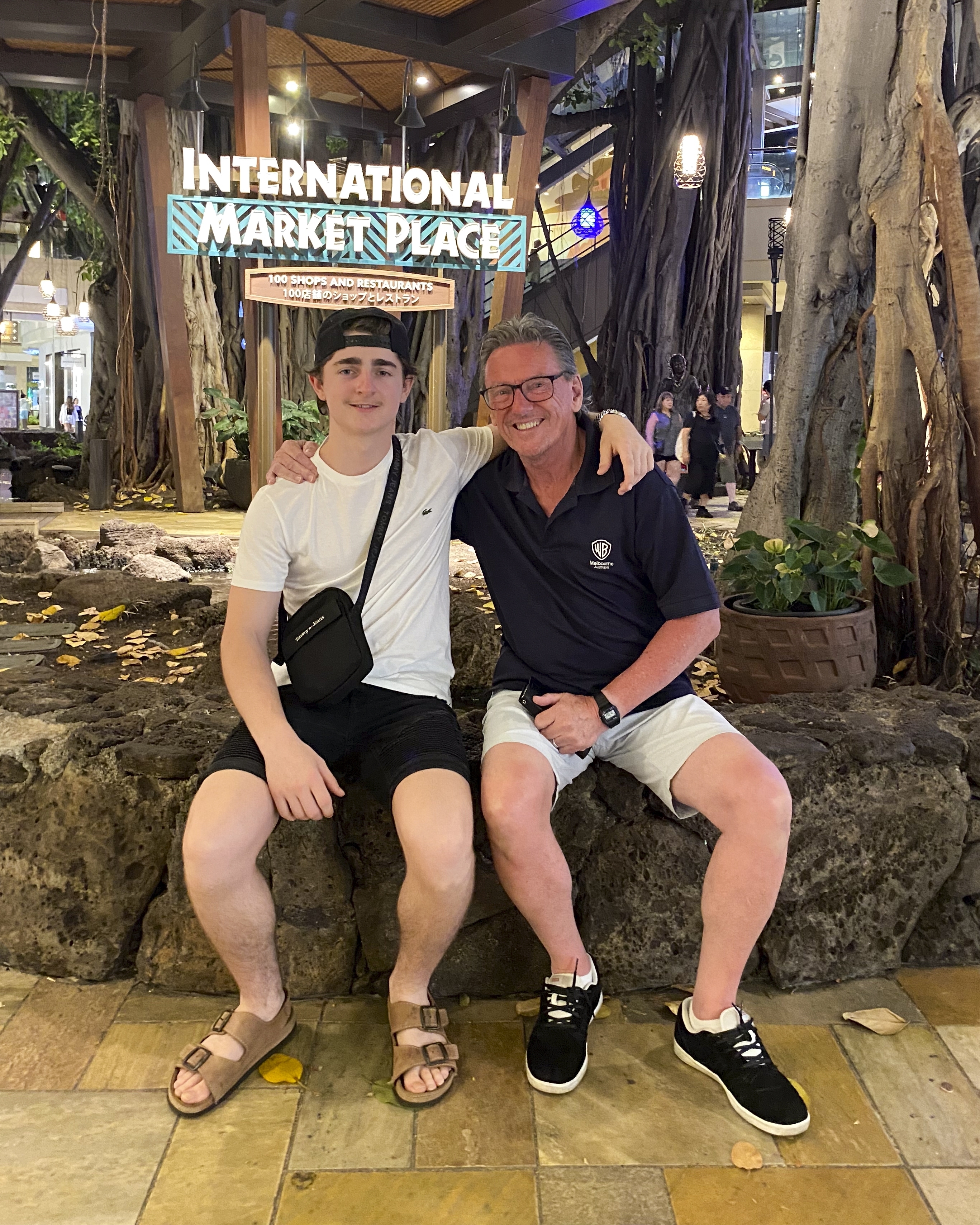 In this October 2023 photo provided by the Holdsworth family, Wayne Holdsworth sits with his son Mac on a family holiday in Hawaii. (Maggie Holdsworth via AP)