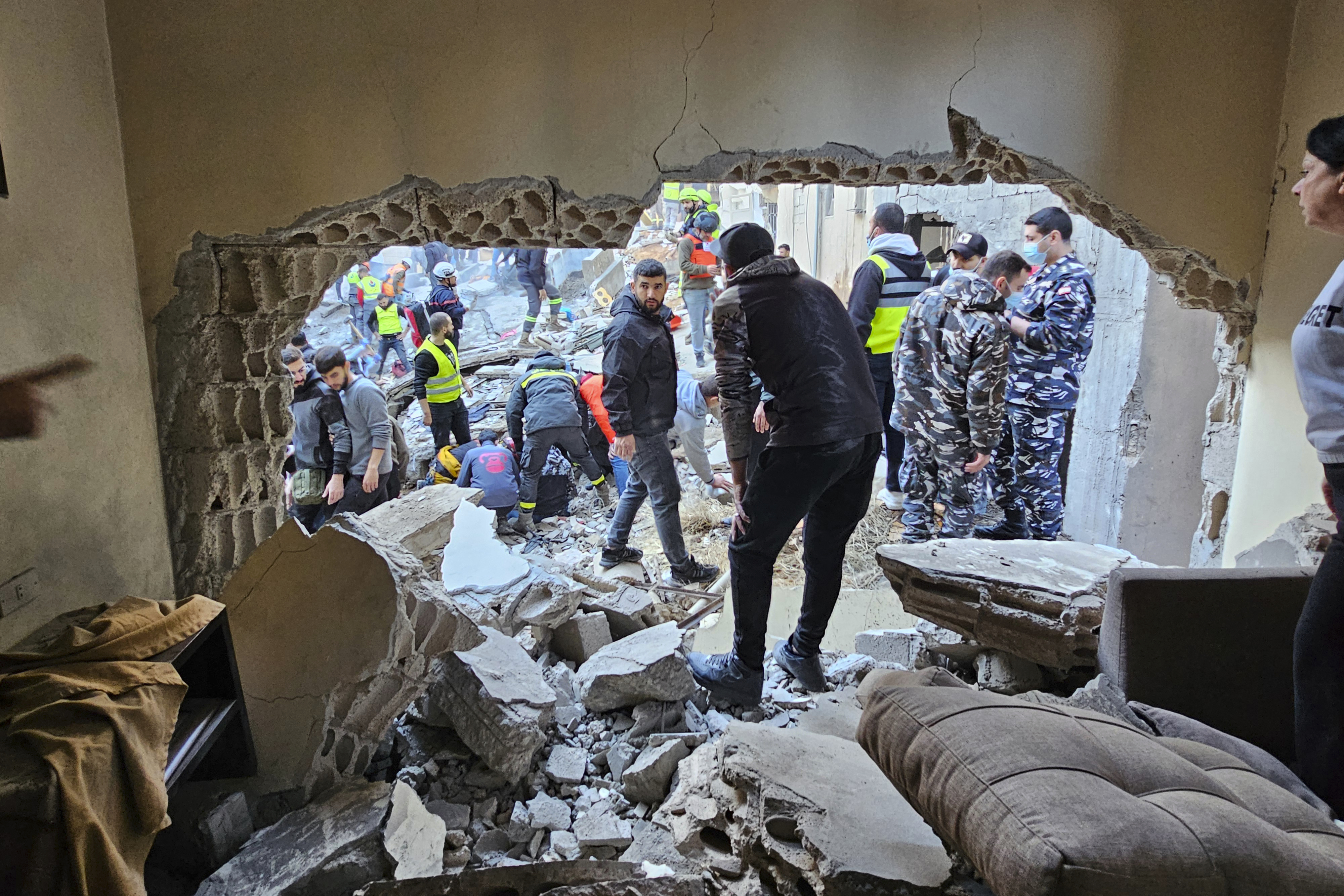 Rescuers and residents search for victims at the site of an Israeli airstrike that targeted a building in Beirut, Lebanon, Tuesday, Nov. 26, 2024. (AP Photo/Hassan Ammar)