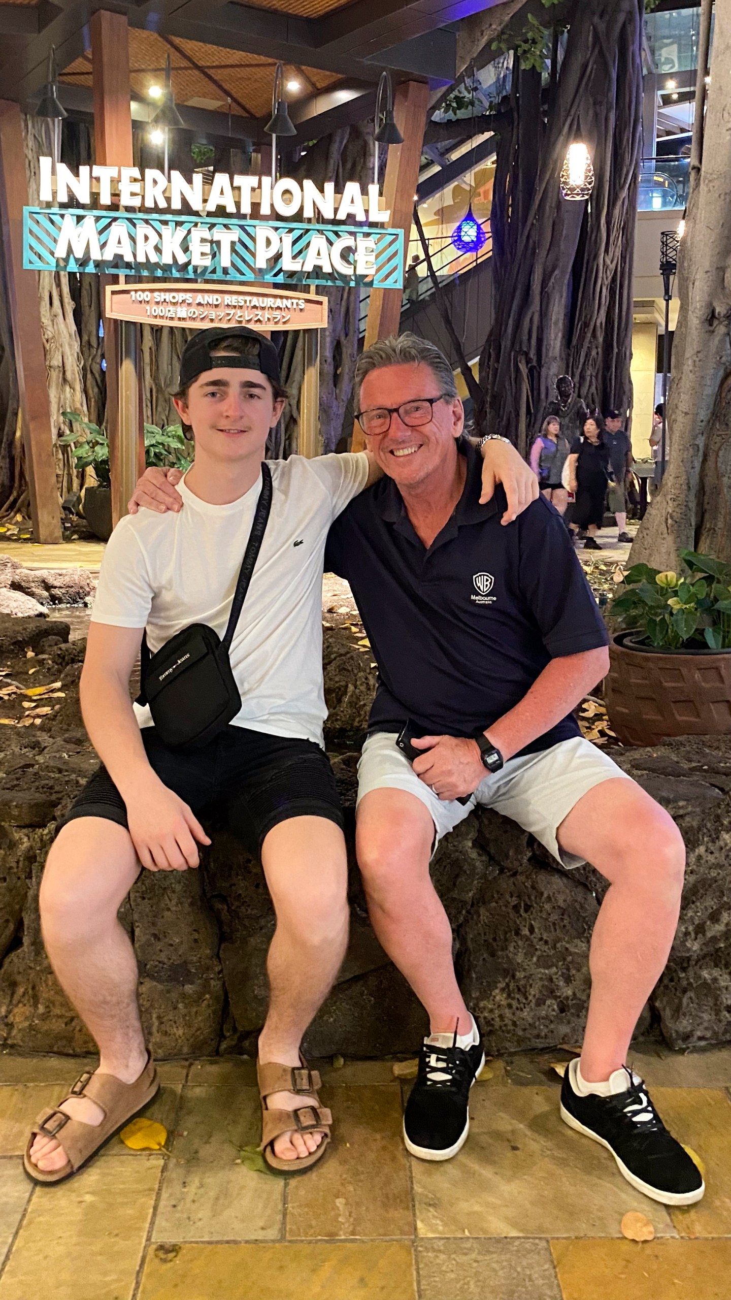 In this October 2023 photo provided by the Holdsworth family, Wayne Holdsworth sits with his son Mac on a family holiday in Hawaii. (Maggie Holdsworth via AP)