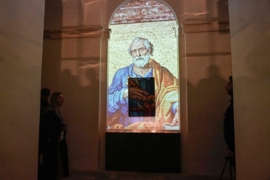 An image of St. Peter is projected on a screen during the preview to the press of the exhibition 'Petros eni', which is part of the project "St. Peter's Basilica: AI-Enhanced Experience" at the Vatican, Saturday, Nov. 9, 2024. (AP Photo/Gregorio Borgia)