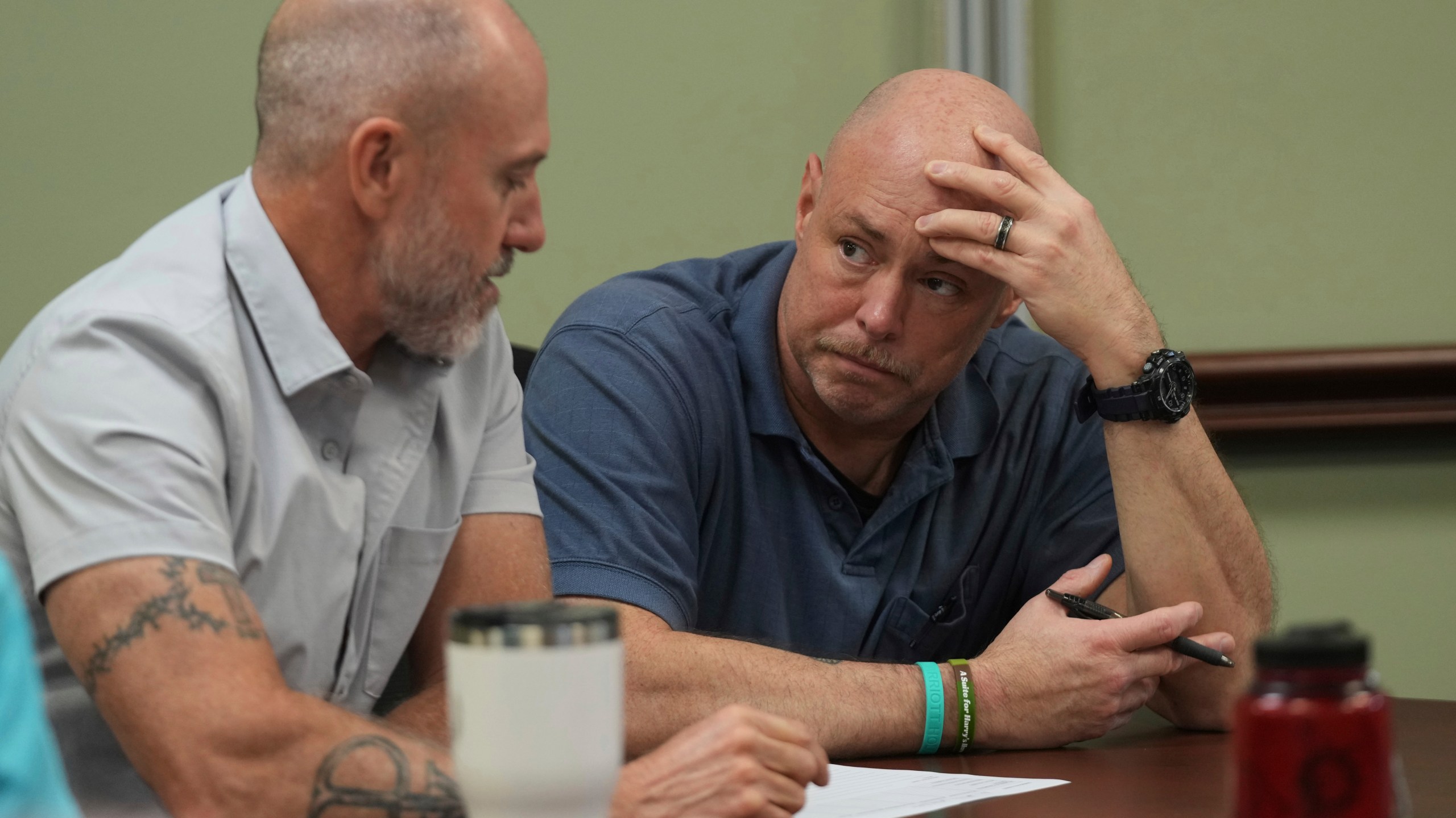 Border Patrol specialist Mitchell Holmes, left, listens to U.S. Fish and Wildlife Regional Law Enforcement agent Kevin Shinn, during a Chaplain Academy training session, Wednesday, Nov. 20, 2024, in Dania Beach, Fla. (AP Photo/Marta Lavandier)