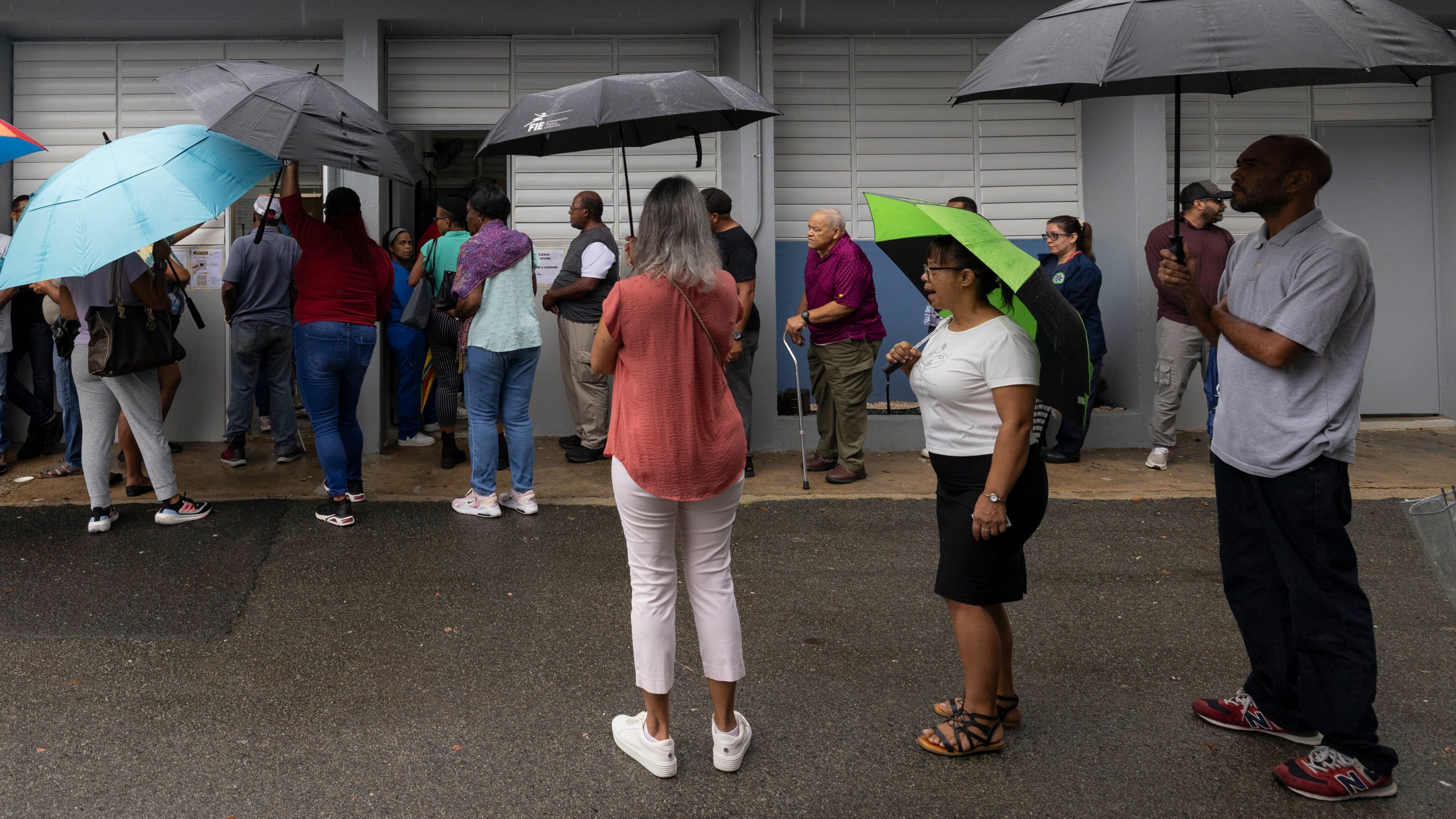 Voters line up at a polling station during general elections in San Juan, Puerto Rico, Tuesday, Nov. 5, 2024. (AP Photo/Alejandro Granadillo)