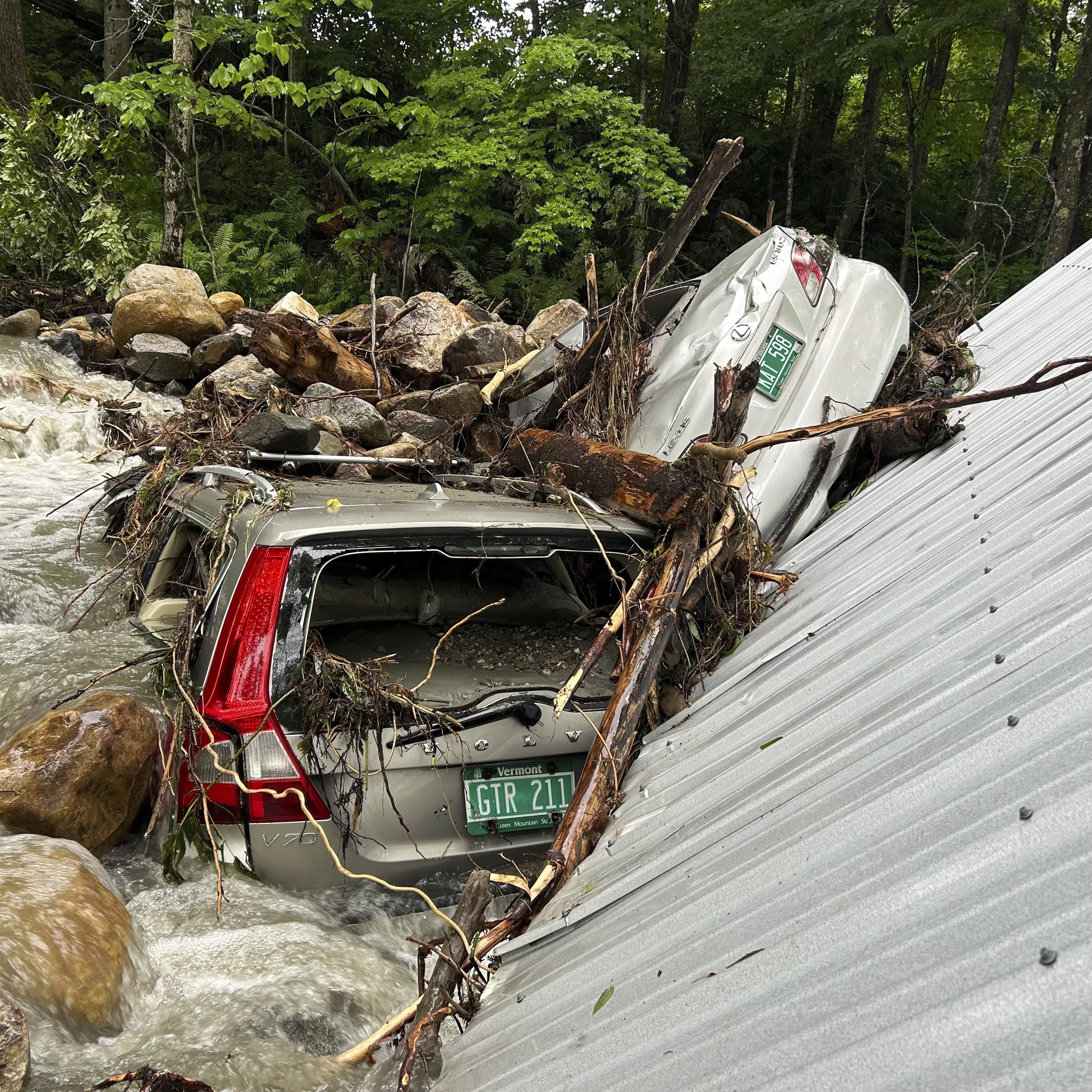 The Mackenzie family's flood-ravaged cars are shown on July 12, 2024, in Peacham, Vt., after severe flooding destroyed their home and vehicles. (Courtesy of Cornelia Hasenfuss via AP)