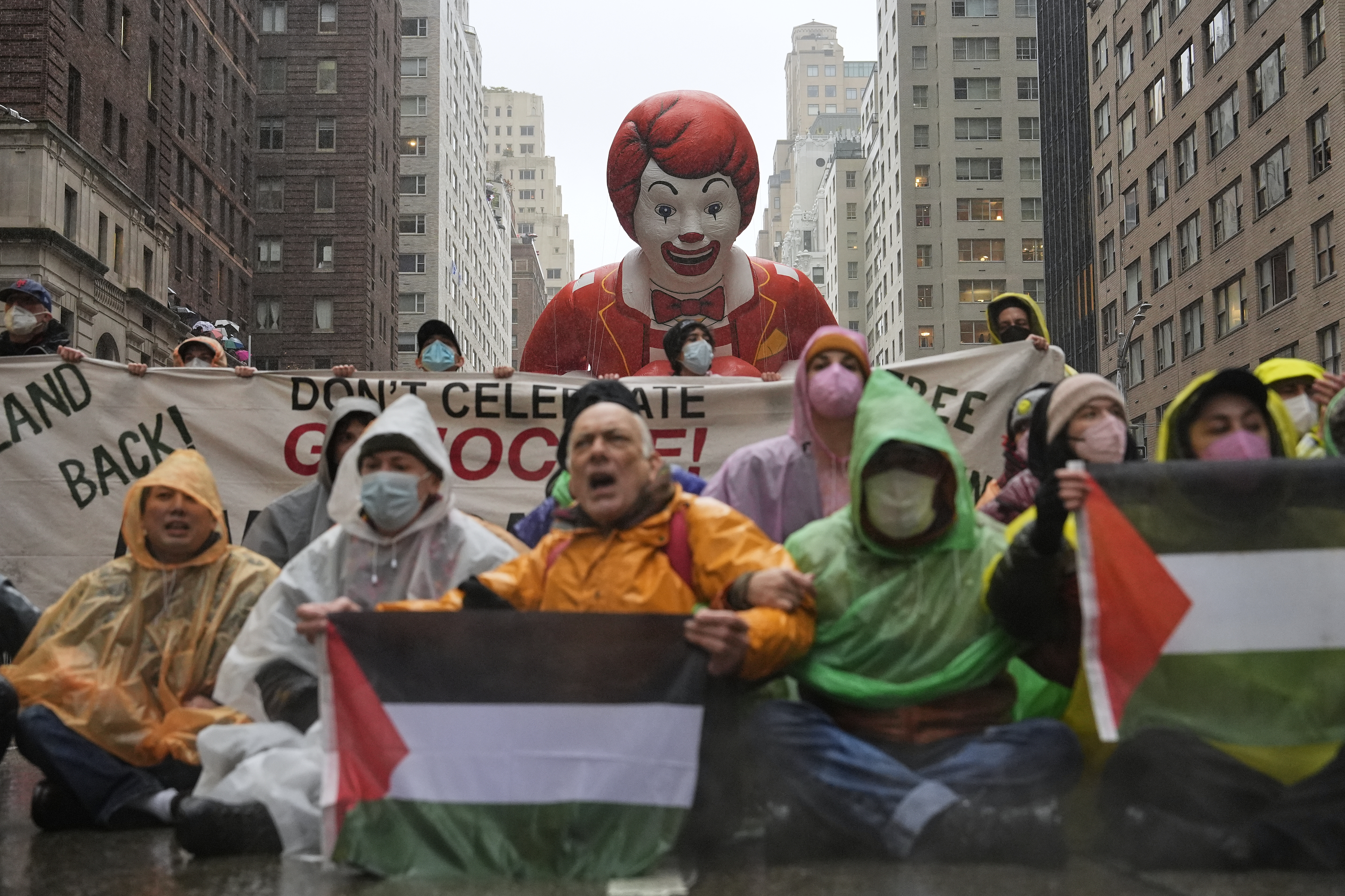 Pro-Palestinian protesters demonstrate on Sixth Avenue during the Macy's Thanksgiving Day Parade, Thursday, Nov. 28, 2024, in New York. (AP Photo/Julia Demaree Nikhinson)