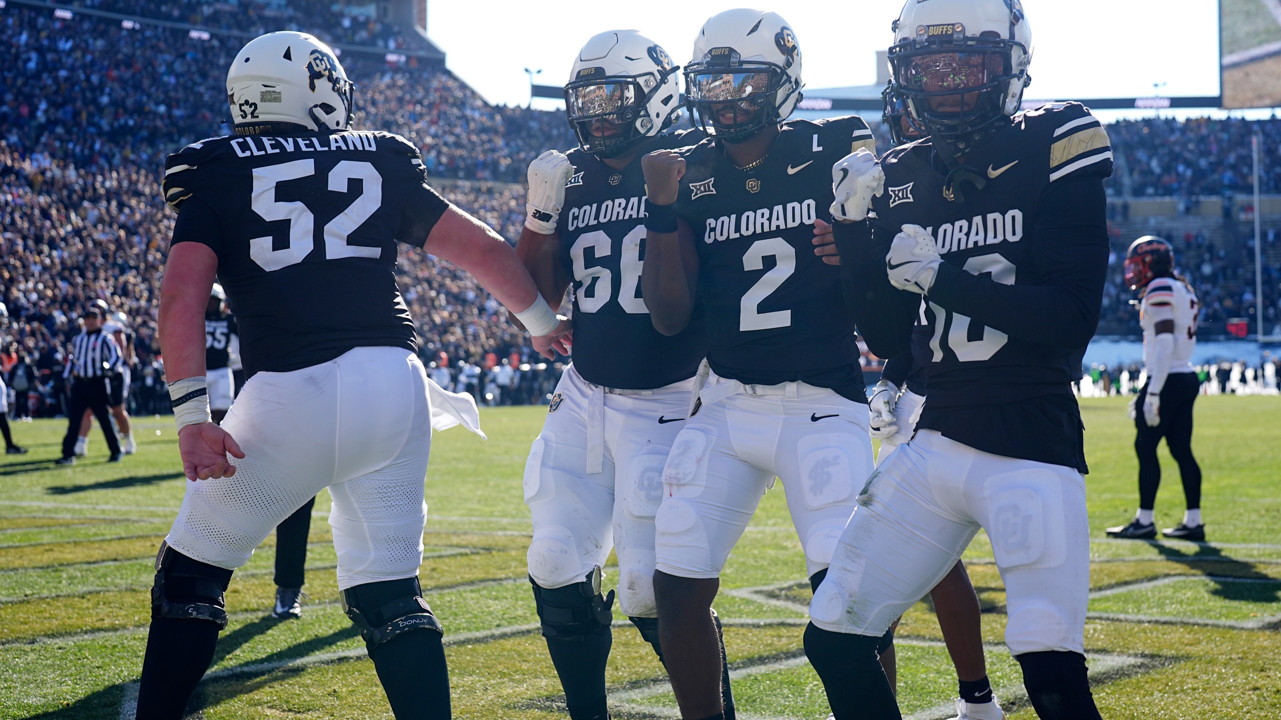 From left; Colorado offensive lineman Cash Cleveland celebrates with offensive lineman Justin Mayers after quarterback Shedeur Sanders tossed a touchdown pass to wide receiver LaJohntay Wester in the first half of an NCAA college football game against Oklahoma State Friday, Nov. 29, 2024, in Boulder, Colo. (AP Photo/David Zalubowski)