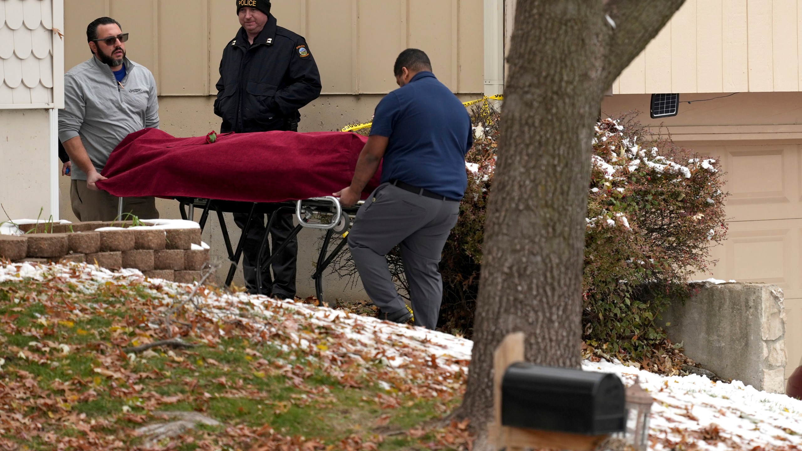 Workers carry a body from the home of former Kansas City, Kan. police detective Roger Golubski on Monday, Dec. 2, 2024, in Edwardsville, Kan. (AP Photo/Charlie Riedel)