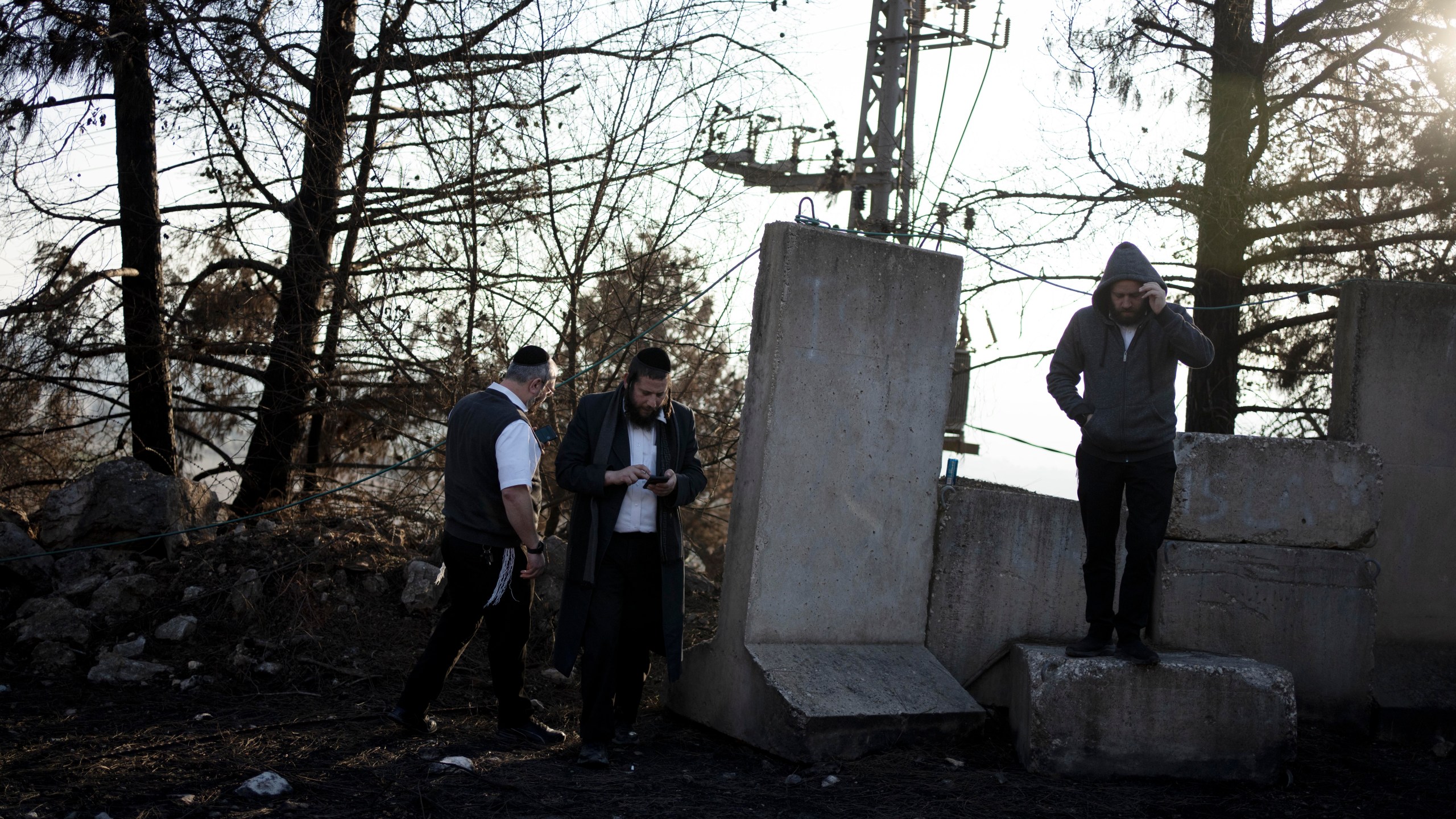 Ultra-Orthodox Jewish men tour northern Israel, near the border with Lebanon, during a ceasefire, Tuesday, Dec. 3, 2024. (AP Photo/Maya Alleruzzo)