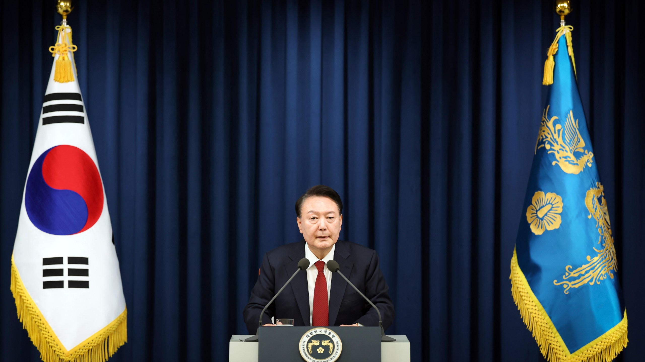 In this photo provided by South Korea Presidential Office, South Korean President Yoon Suk Yeol speaks during a press briefing at the presidential office in Seoul, South Korea, Tuesday, Dec. 3, 2024. (South Korea Unification Ministry via AP).