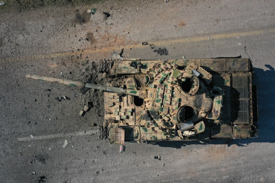 An abandoned Syrian army armoured vehicle sits on a road controlled by Syrian insurgents in the outskirts of Hama, Syria, Tuesday Dec. 3, 2024.(AP Photo/Ghaith Alsayed)