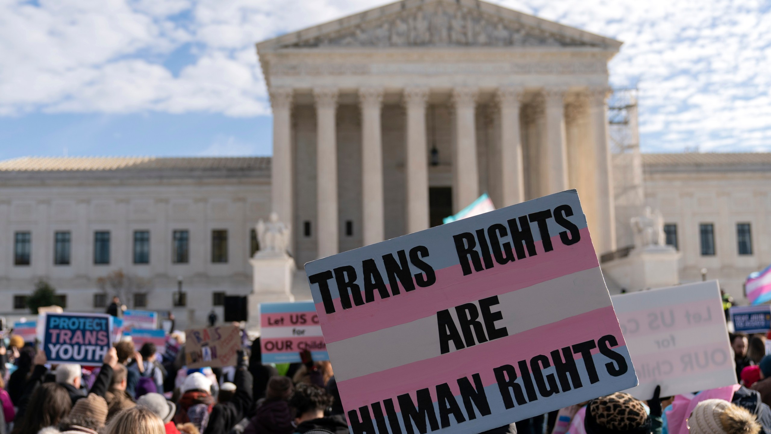 Transgenders rights supporters rally outside of the Supreme Court, Wednesday, Dec. 4, 2024, in Washington. (AP Photo/Jose Luis Magana)