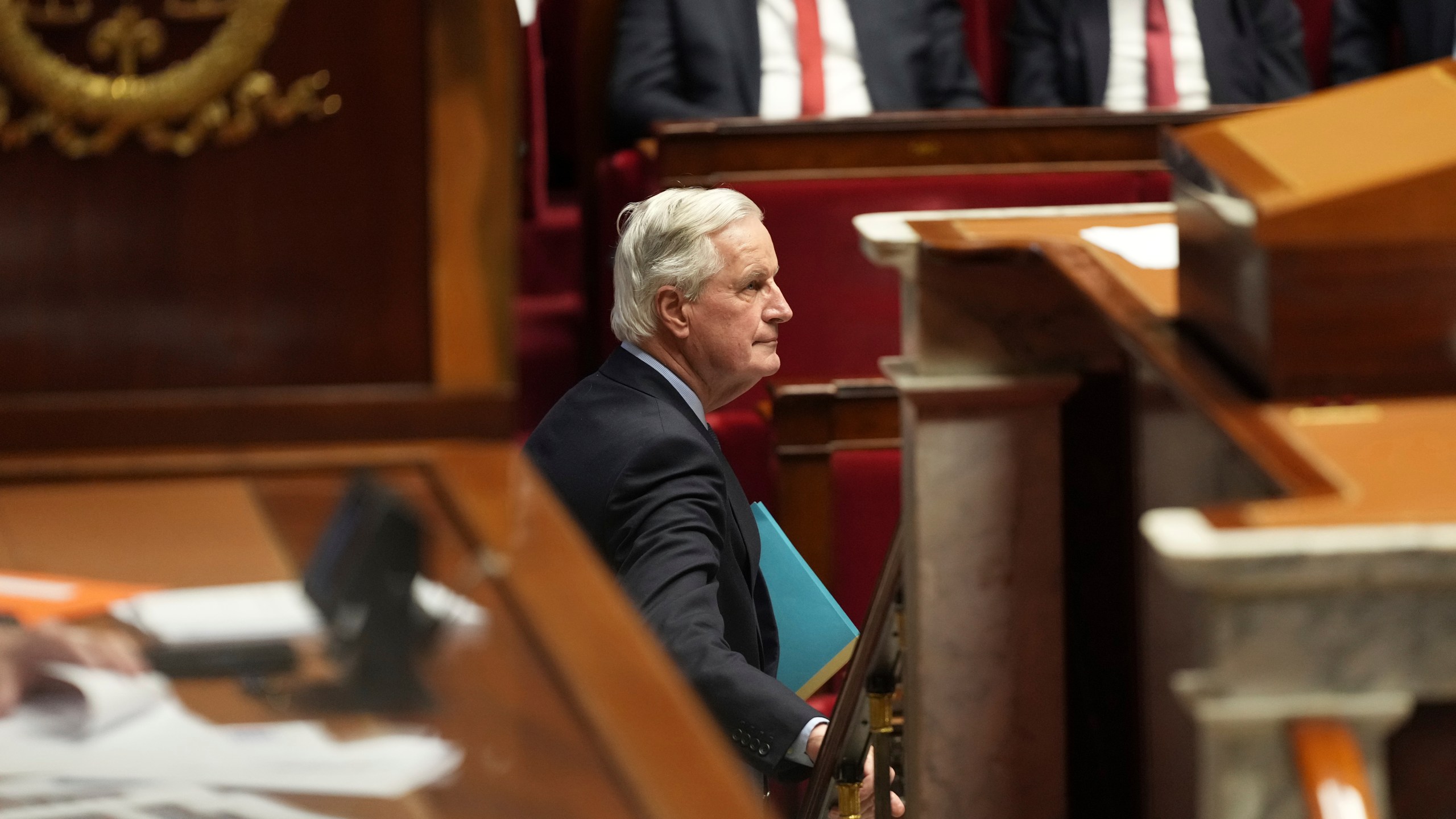 French Prime Minister Michel Barnier leaves after addressing the National Assembly prior to a vote on a no-confidence motion that could bring him down and his cabinet for the first time since 1962, Wednesday, Dec. 4, 2024 in Paris. (AP Photo/Michel Euler)