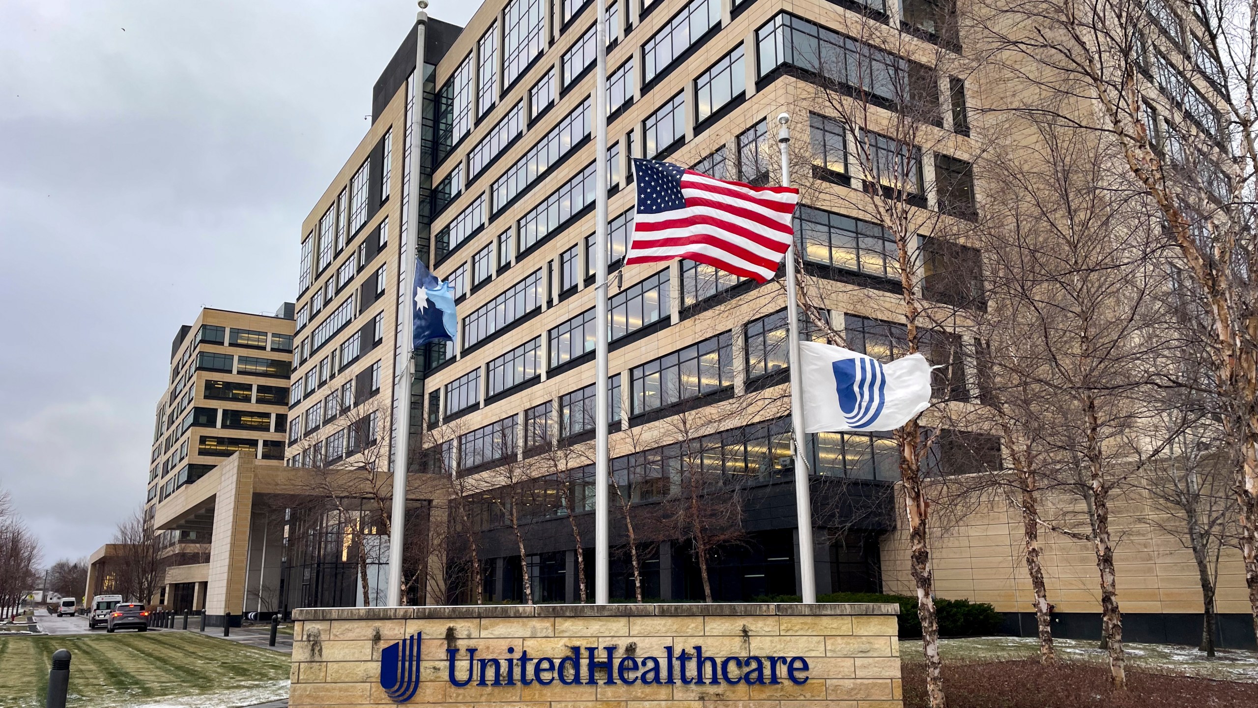 The UnitedHealthcare headquarters in Minnetonka, Minn., lowered its flags to half-staff on Wednesday, Dec. 4, 2024, in honor of CEO Brian Thompson, who was fatally shot outside a hotel in New York. (Kerem Yücel/Minnesota Public Radio via AP)