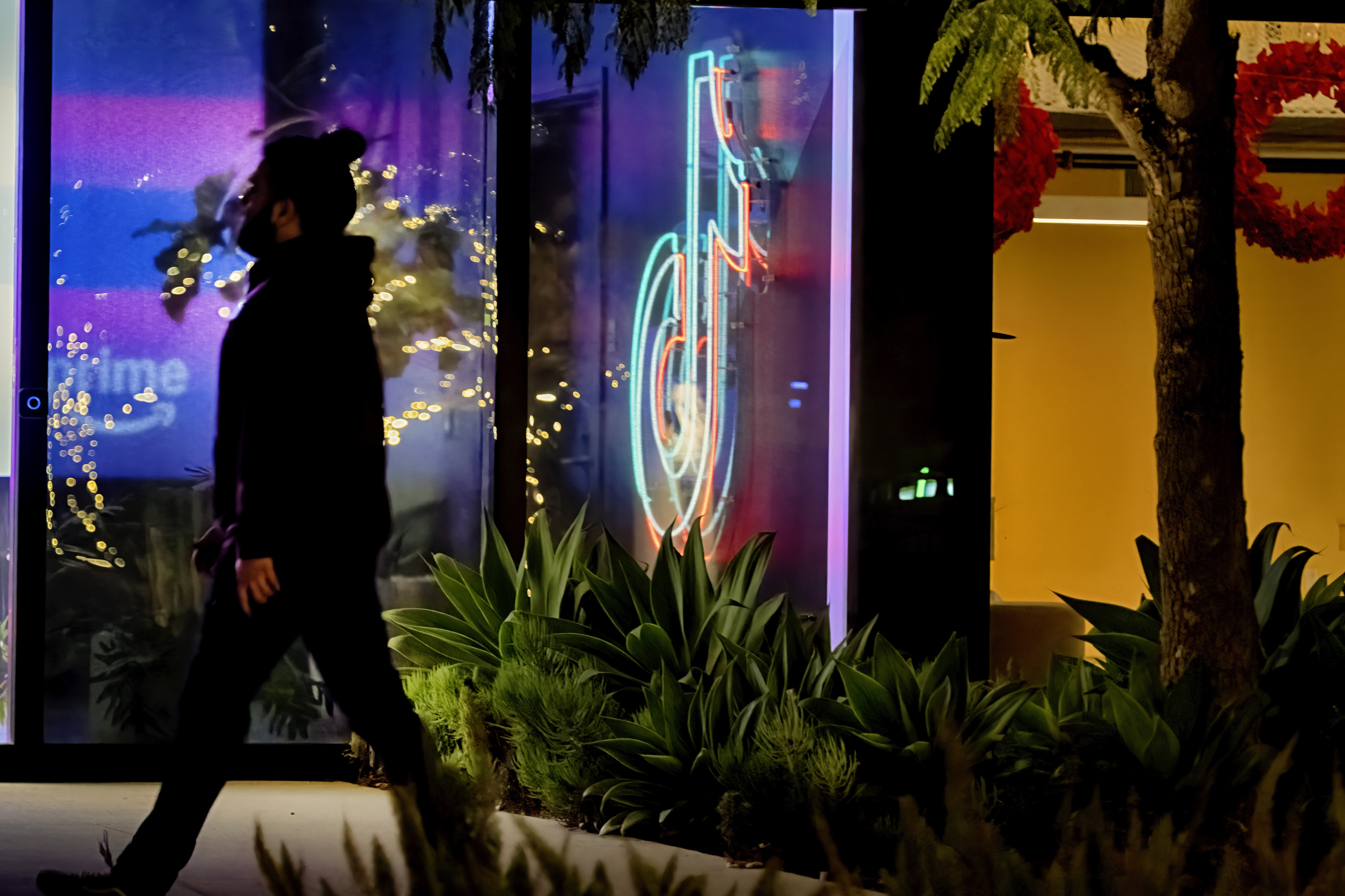 A neon TikTok logo hangs in the lobby of the TikTok office building in Culver City, Calif., on Tuesday, Dec. 3, 2024. (AP Photo/Richard Vogel)