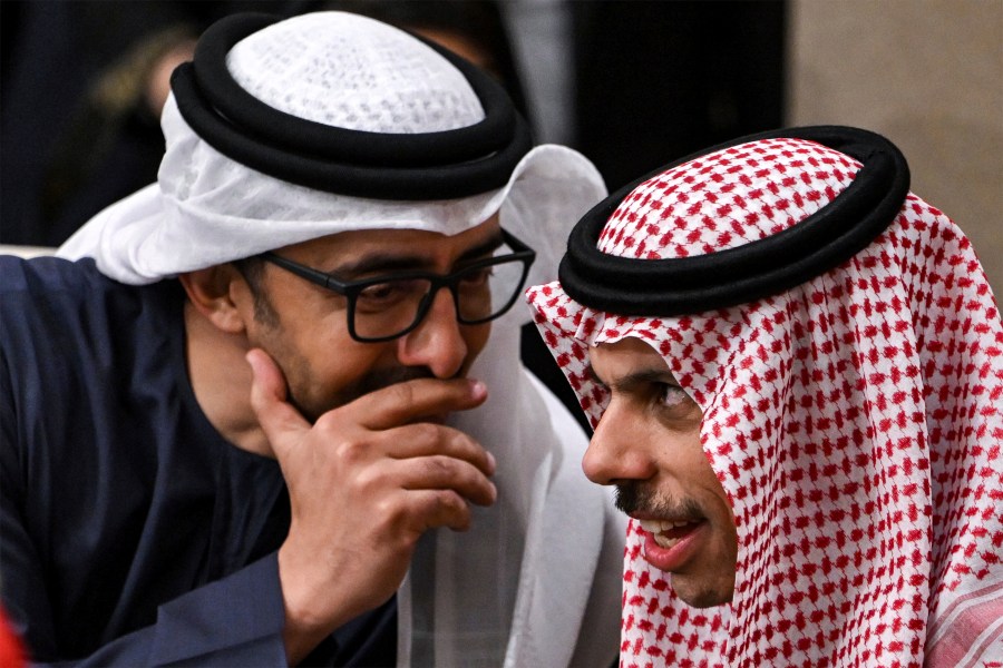 The UAE's Foreign Minister Sheikh Abdullah bin Zayed al-Nahyan, left, speaks with Saudi Arabia's Foreign Minister Prince Faisal bin Farhan al-Saud during a meeting with the foreign ministers of the Arab Contact Group on Syria in Jordan's southern Red Sea coastal city of Aqaba, Saturday Dec. 14, 2024. (Andrew Caballero-Reynolds/Pool via AP)