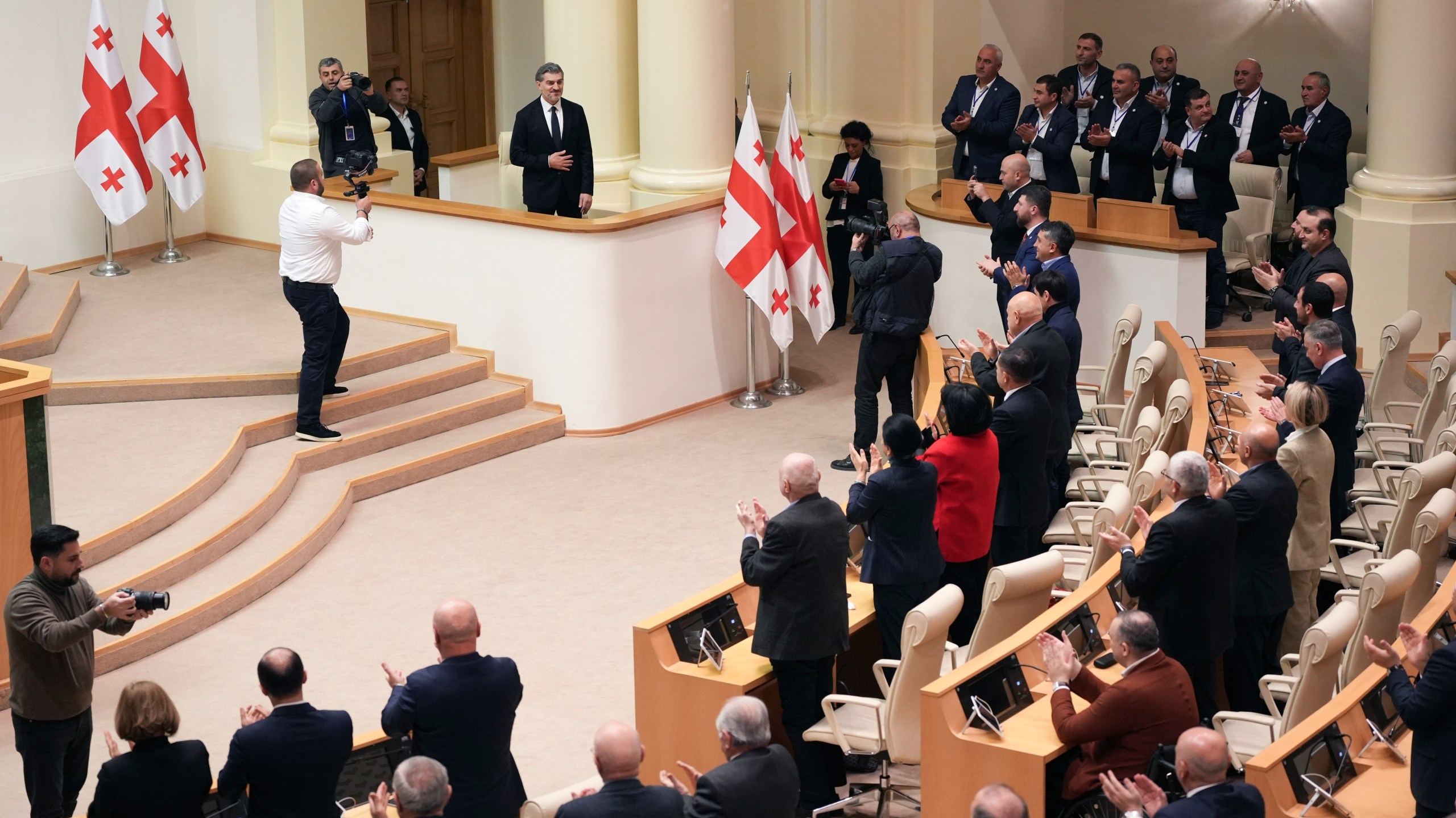 Georgian president-elect Mikheil Kavelashvili is greeted by the electoral college members at the Georgian parliament, in Tbilisi, Georgia, Saturday. Dec. 14, 2024. (AP Photo)