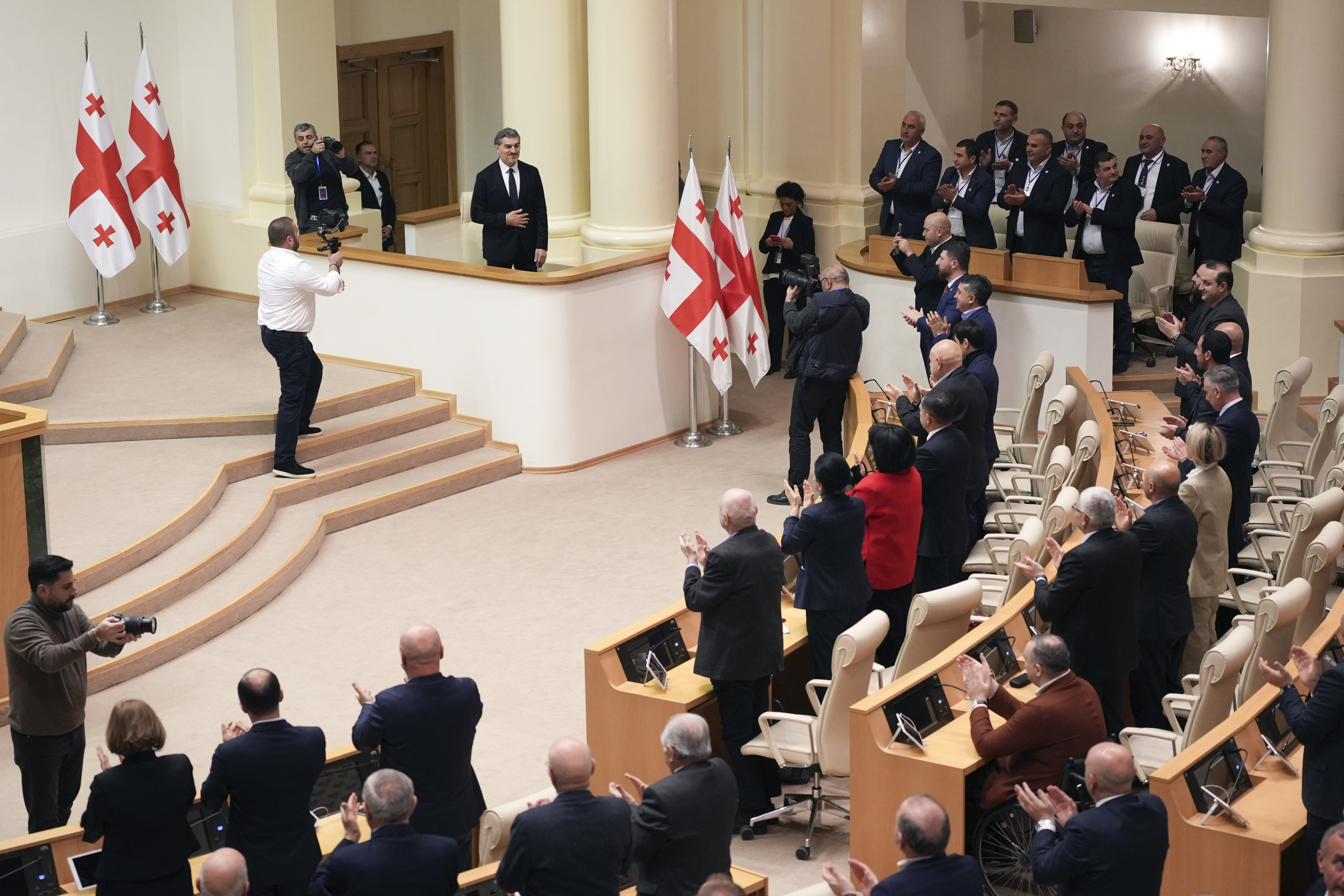 Georgian president-elect Mikheil Kavelashvili is greeted by the electoral college members at the Georgian parliament, in Tbilisi, Georgia, Saturday. Dec. 14, 2024. (AP Photo)