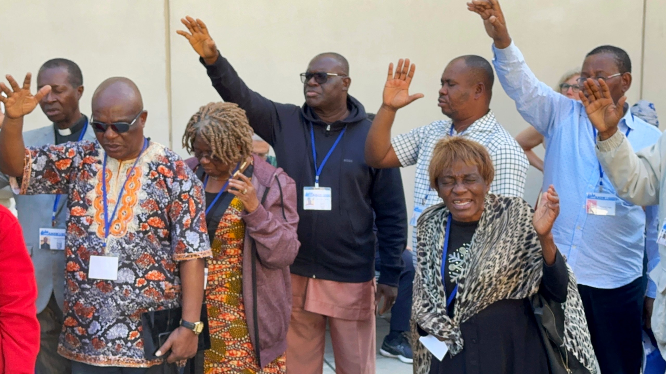 FILE - African delegates to the General Conference of the United Methodist Church pray outside the Charlotte Convention Center, in Charlotte, N.C., Thursday, May 2, 2024. (AP Photo/Peter Smith, File)