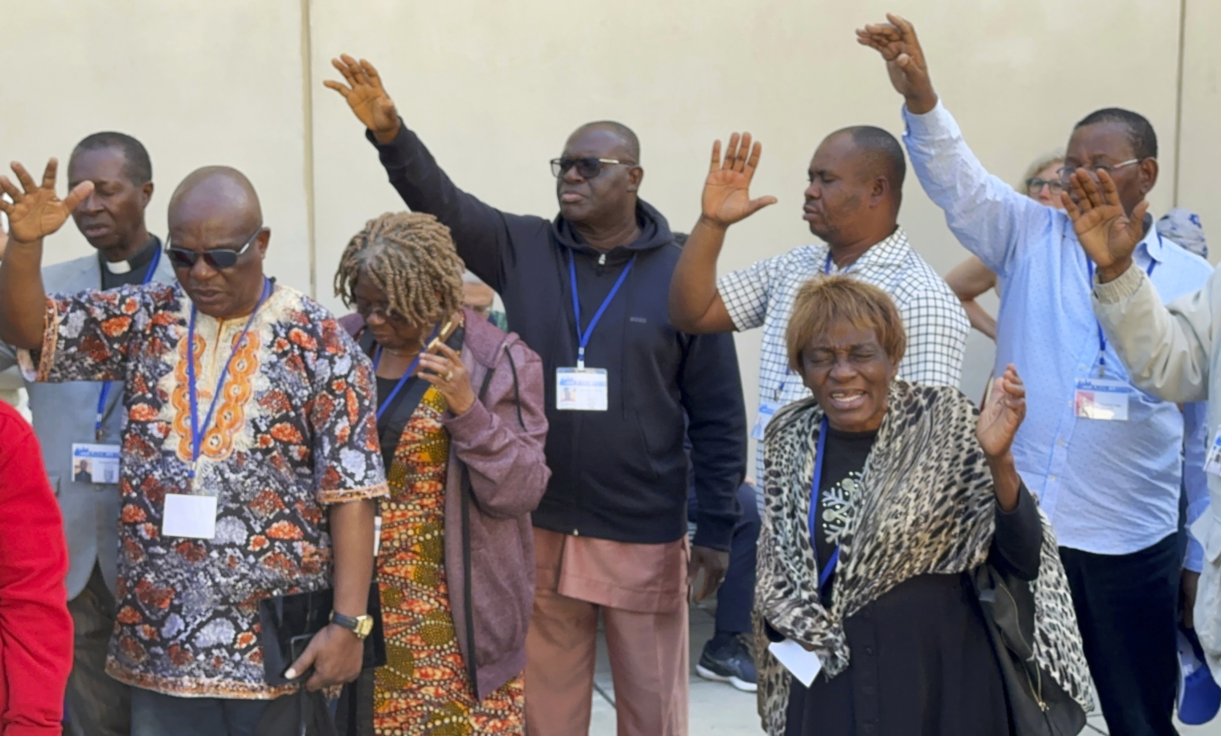 FILE - African delegates to the General Conference of the United Methodist Church pray outside the Charlotte Convention Center, in Charlotte, N.C., Thursday, May 2, 2024. (AP Photo/Peter Smith, File)