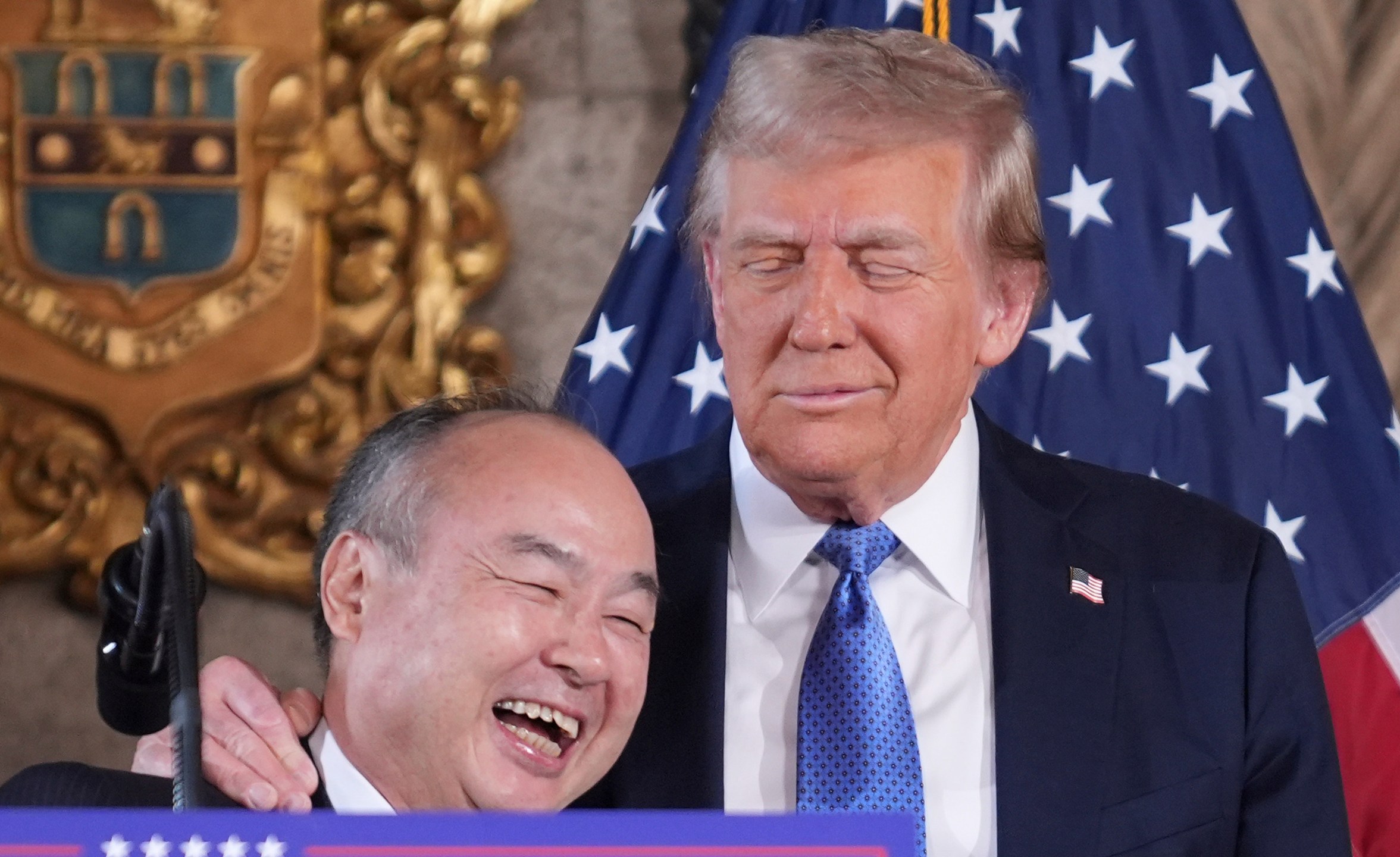 SoftBank Group CEO Masayoshi Son smiles with President-elect Donald Trump during a news conference at Mar-a-Lago, Monday, Dec. 16, 2024, in Palm Beach, Fla. (AP Photo/Evan Vucci)