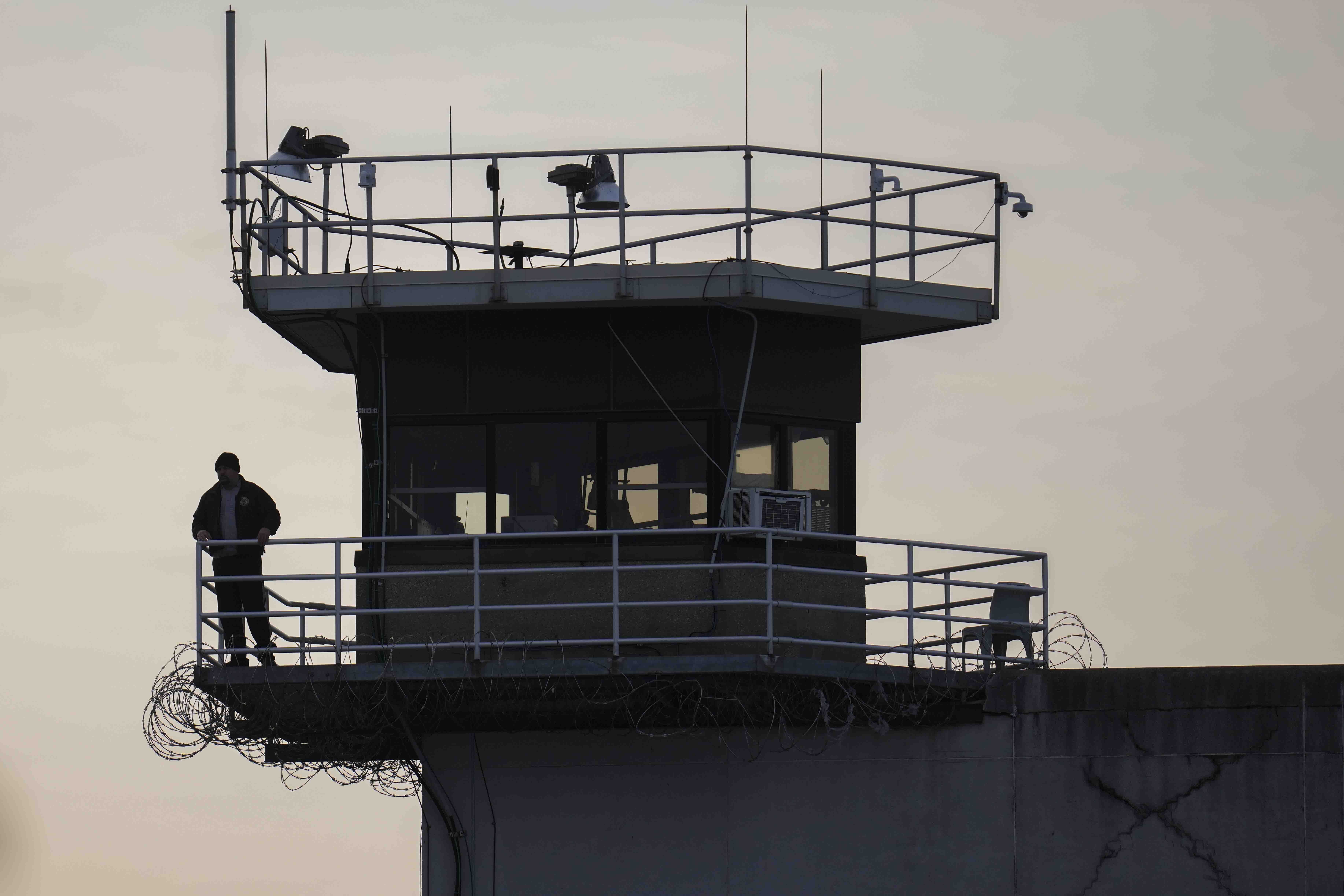 A guard stands in a tower at Indiana State Prison where, barring last-minute court action or intervention by Gov. Eric Holcomb, Joseph Corcoran, 49, convicted in the 1997 killings of his brother and three other people, is scheduled to be put to death by lethal injection before sunrise Tuesday, Dec. 17, 2024, in Michigan City, Ind. (AP Photo/Erin Hooley)