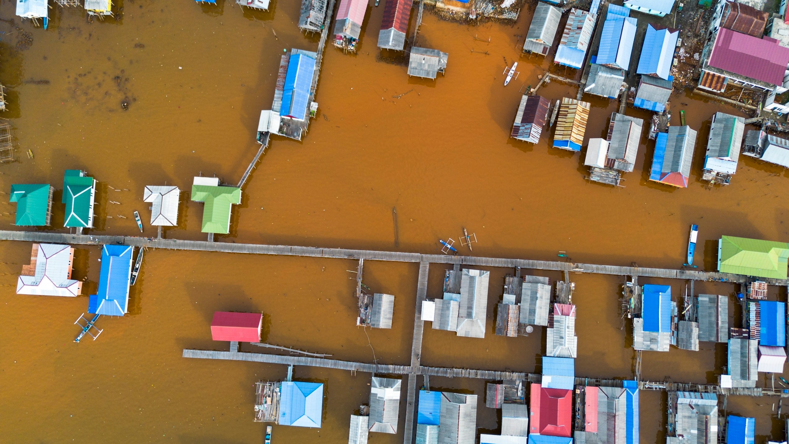 Murky brown water is visible near nickel mining activities that surround Baliara village on Kabaena Island, Southeast Sulawesi, Friday, Nov. 15, 2024. (AP Photo/Yusuf Wahid)