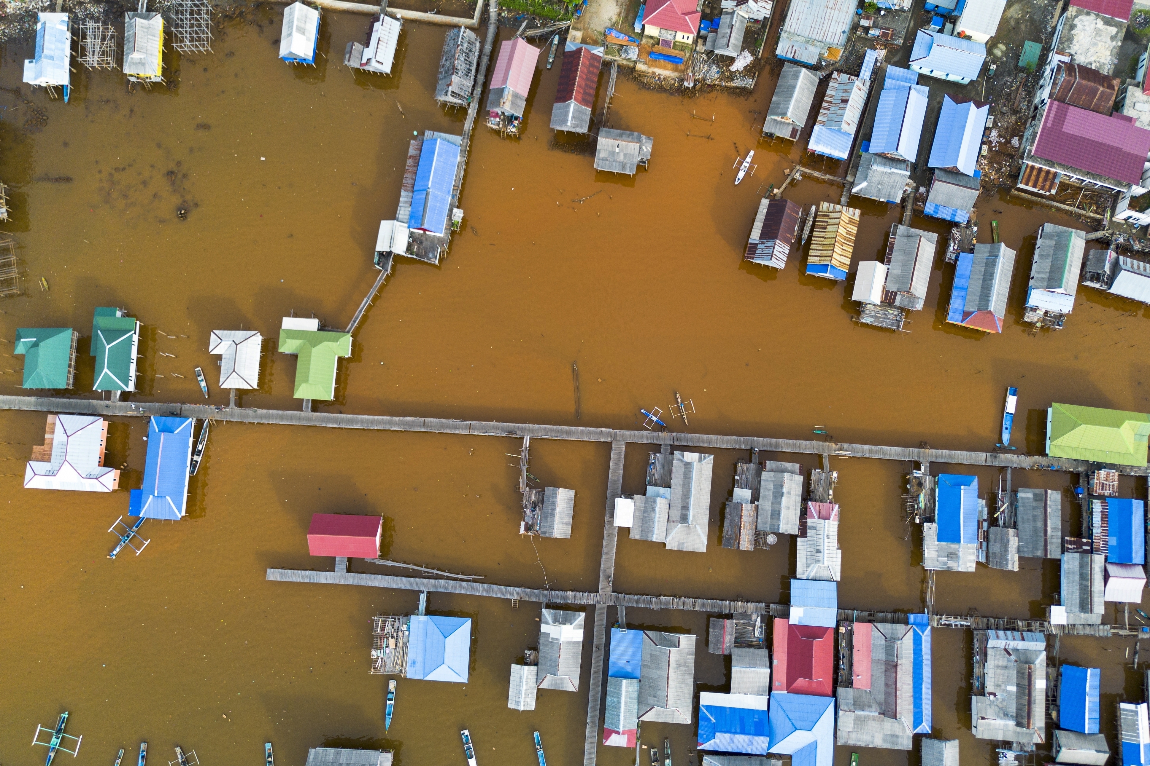 Murky brown water is visible near nickel mining activities that surround Baliara village on Kabaena Island, Southeast Sulawesi, Friday, Nov. 15, 2024. (AP Photo/Yusuf Wahid)