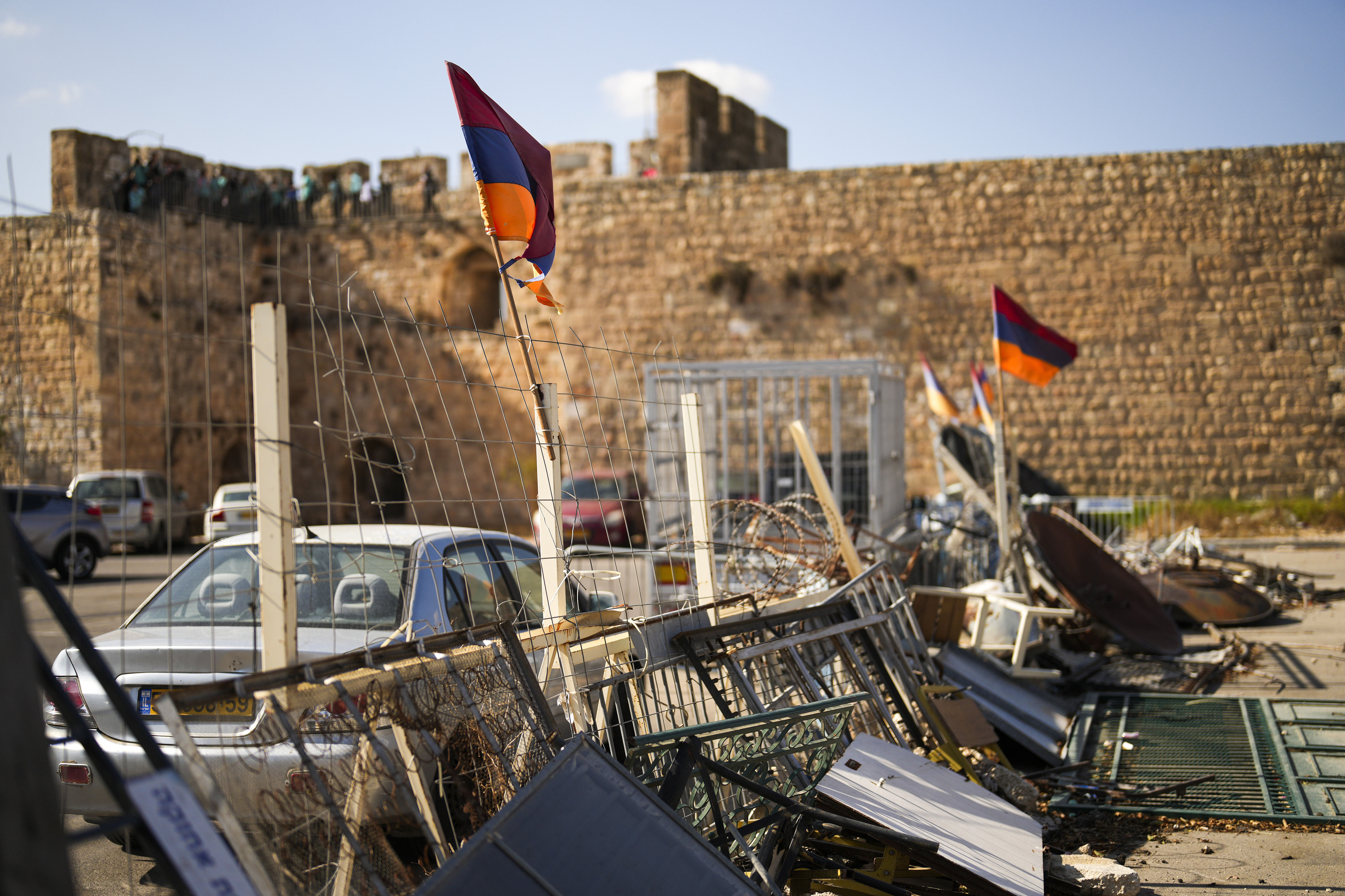 Armenian flags wave in a makeshift barricade set up by local activists in a parking area known as "Cows garden" at the Armenian quarter in Jerusalem, Thursday, Nov. 21, 2024. (AP Photo/Francisco Seco)