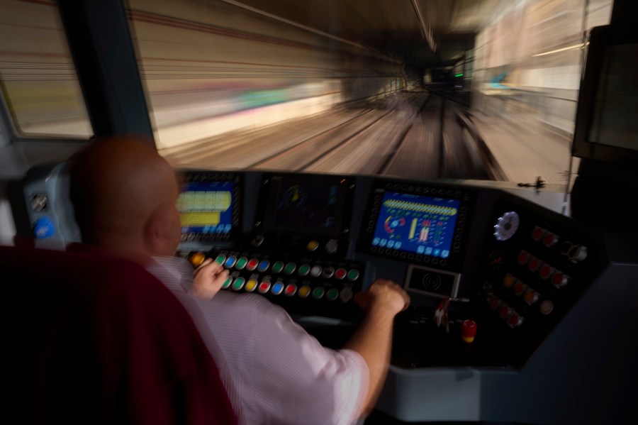 A subway driver operates the train's brake lever before entering a station in Barcelona, Spain, Monday, Dec. 2, 2024. (AP Photo/Emilio Morenatti)