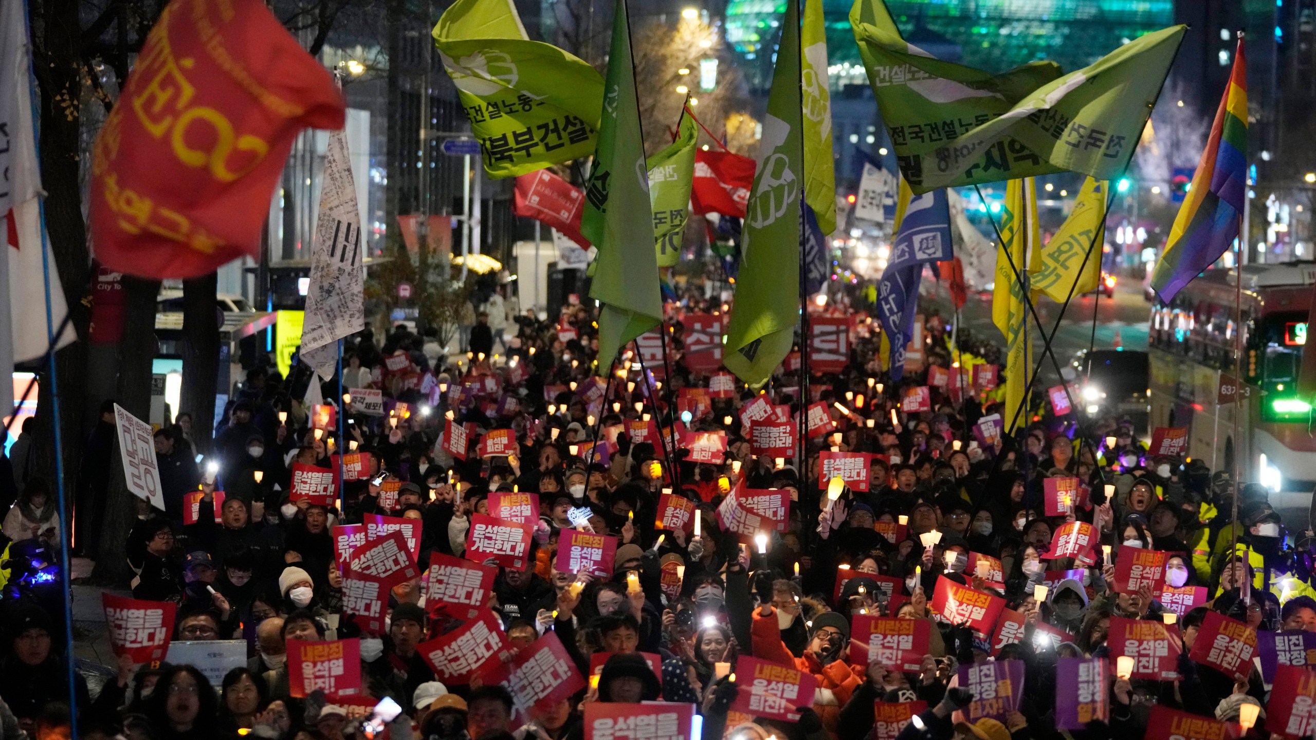 FILE - Protesters march to the presidential office after a candlelight vigil against South Korean President Yoon Suk Yeol in Seoul, South Korea, Dec. 5, 2024. (AP Photo/Ahn Young-joon, File)