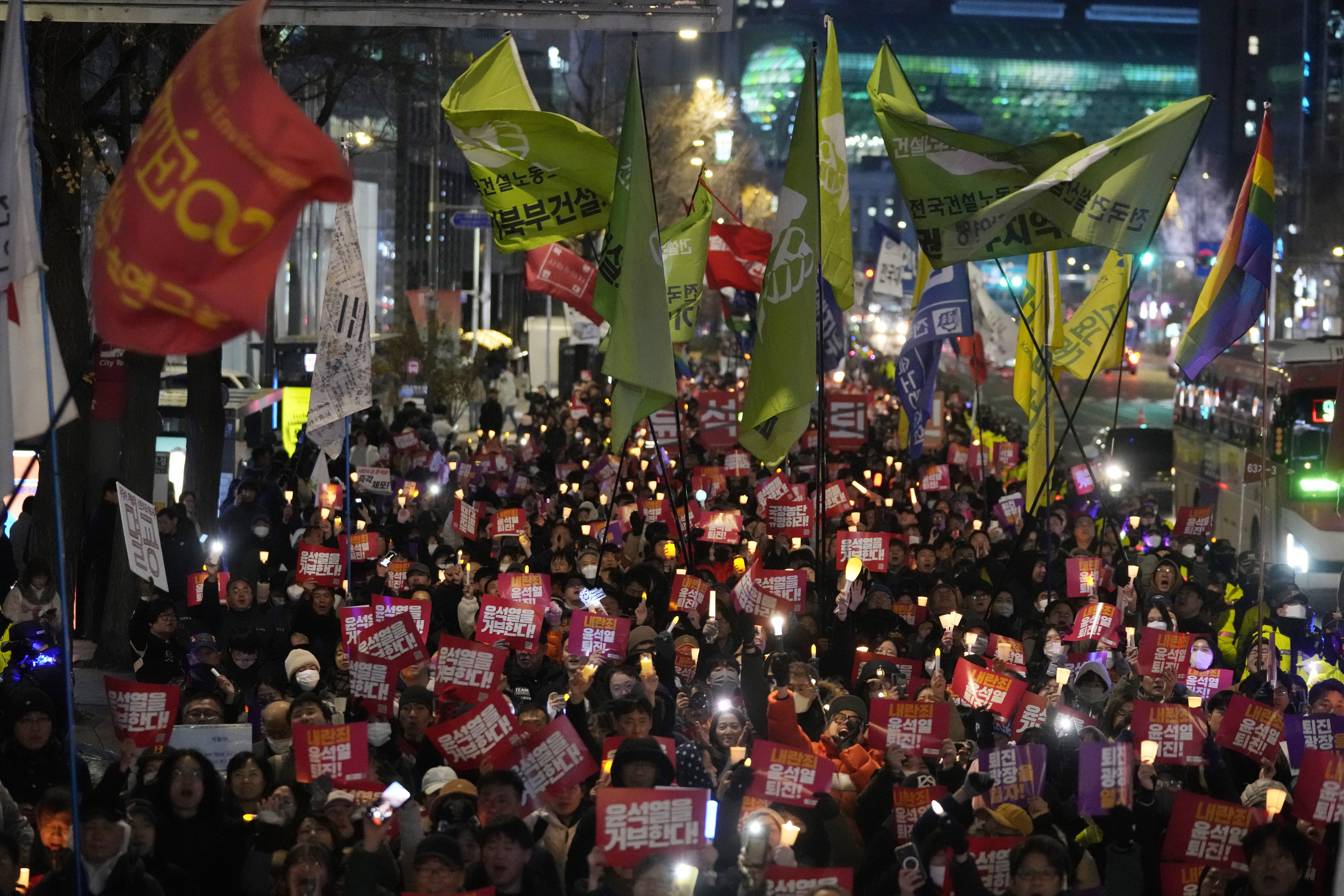 FILE - Protesters march to the presidential office after a candlelight vigil against South Korean President Yoon Suk Yeol in Seoul, South Korea, Dec. 5, 2024. (AP Photo/Ahn Young-joon, File)