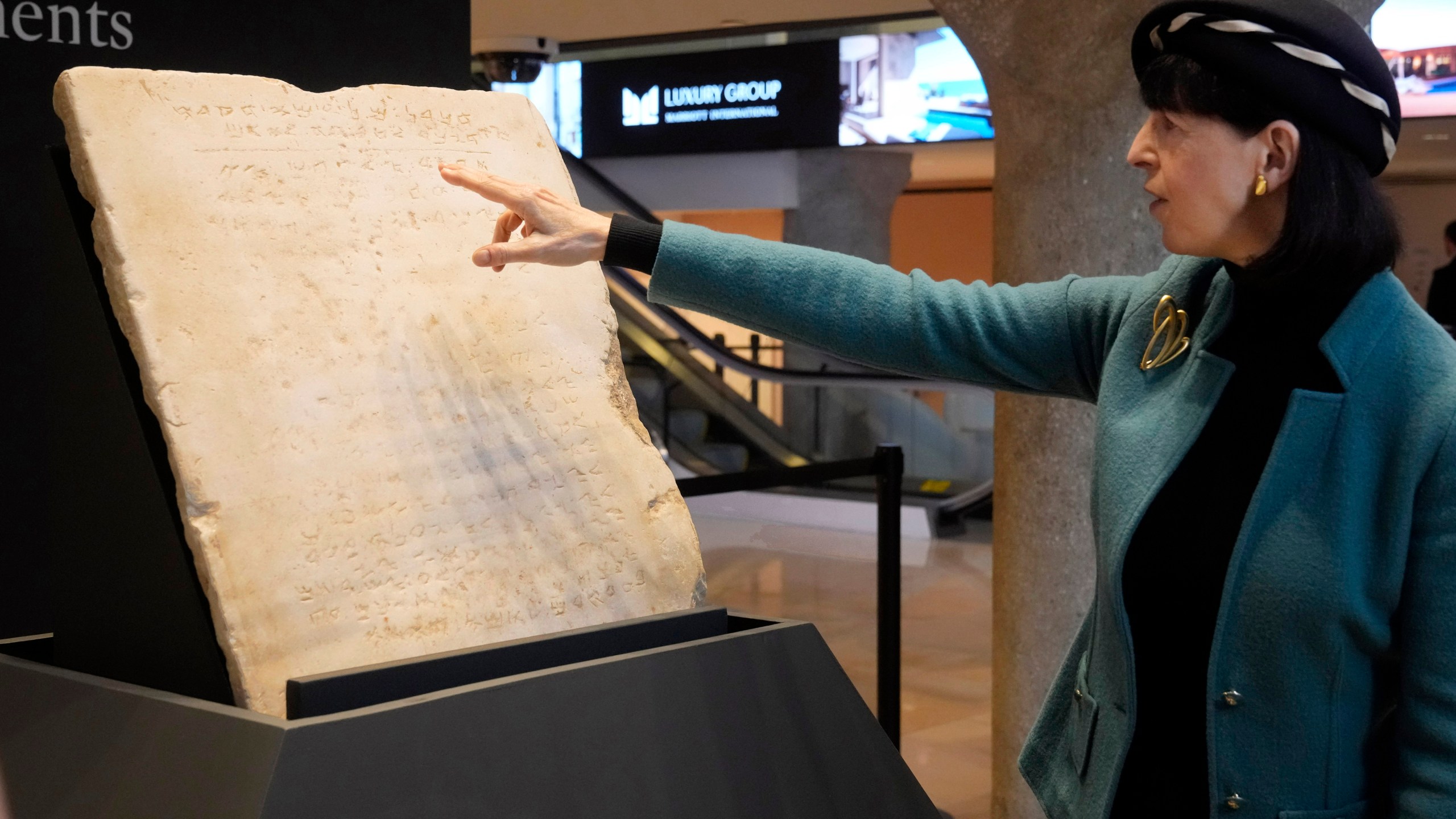 Sharon Liberman Mintz, Sotheby's Judaica Specialist, Books & Manuscripts, discusses the oldest complete tablet of the Ten Commandments, weighing 115-pounds and approximately 1,500 years old, that is displayed at Sotheby's, in New York, Monday, Dec. 9, 2024, where it is to be offered for auction in a single lot sale, Dec, 18, 2024. (AP Photo/Richard Drew)