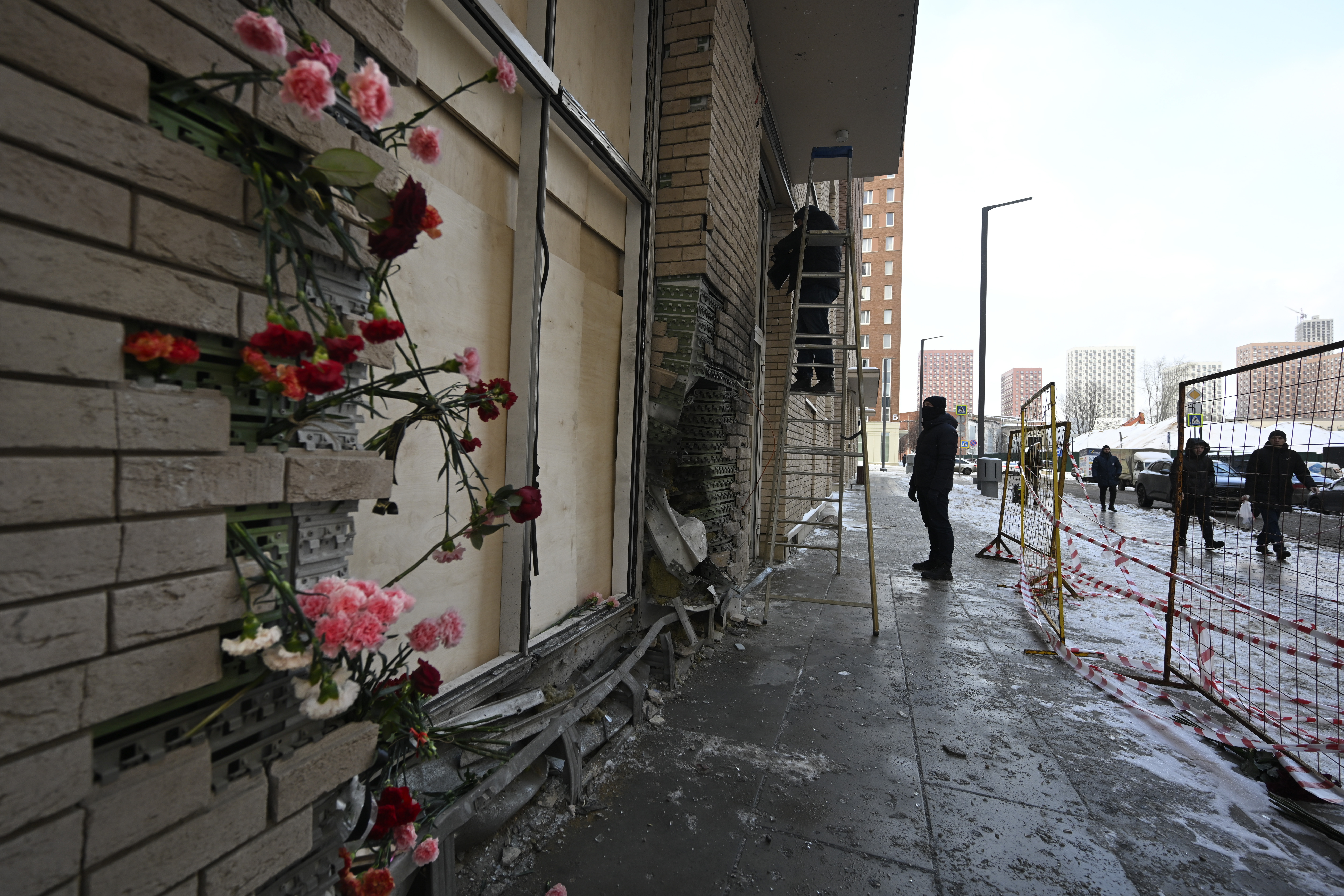 Flowers are attached to the facade of an apartment block in Moscow, Russia, on Wednesday, Dec. 18, 2024, where a bomb killed Lt. Gen. Igor Kirillov, the head of Russia's Radiation, Biological, and Chemical Defense Forces, and his assistant, Ilya Polikarpov. (AP Photo/Dmitry Serebryakov)