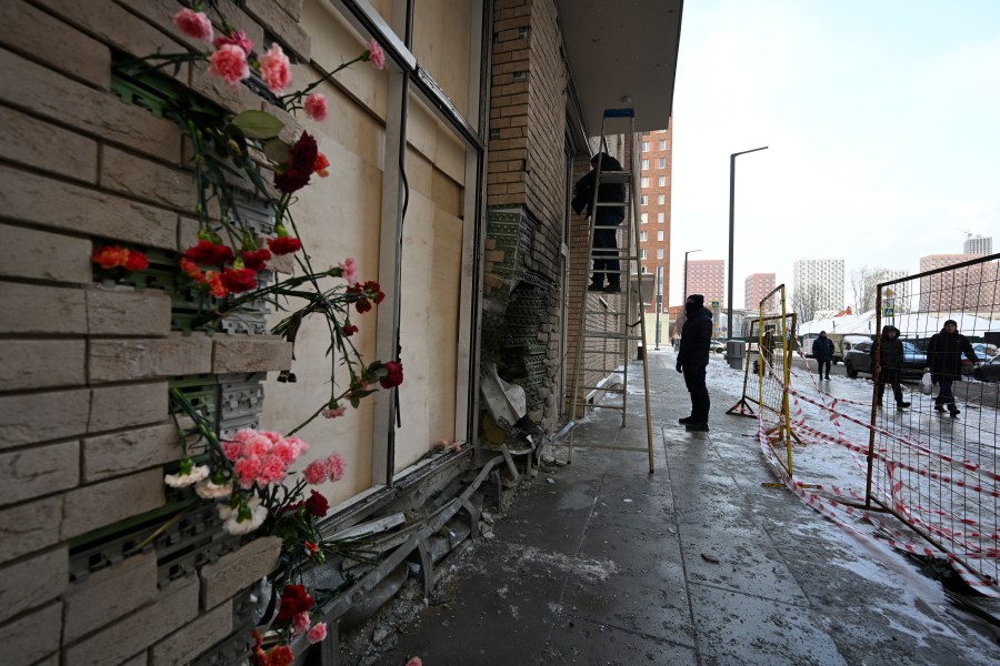 Flowers are attached to the facade of an apartment block in Moscow, Russia, on Wednesday, Dec. 18, 2024, where a bomb killed Lt. Gen. Igor Kirillov, the head of Russia's Radiation, Biological, and Chemical Defense Forces, and his assistant, Ilya Polikarpov. (AP Photo/Dmitry Serebryakov)