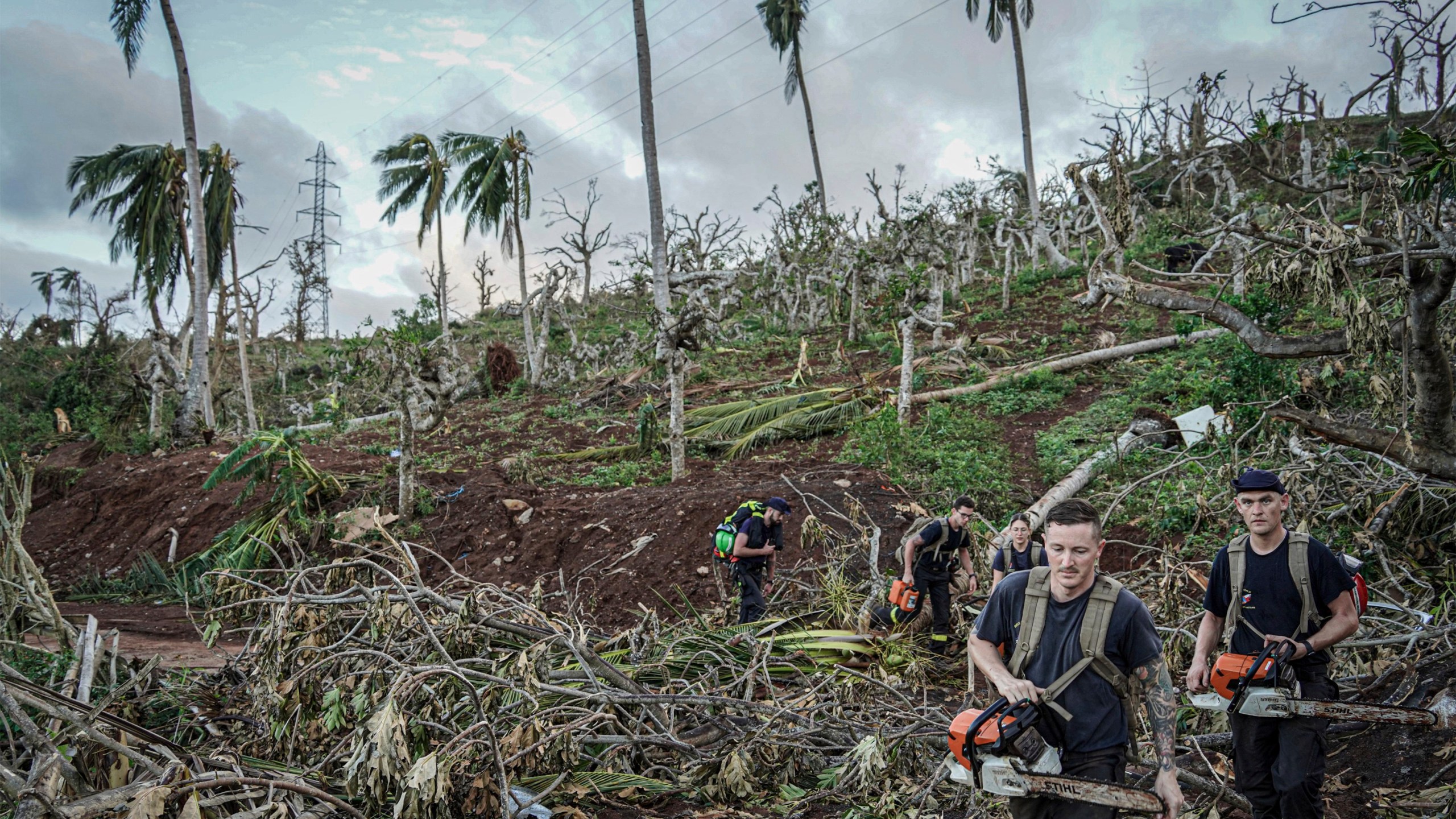 This photo provided by the French Interior Ministry shows rescue workers making their way in a devastated area of the French territory of Mayotte in the Indian Ocean, after the island was battered by its worst cyclone in nearly a century, Tuesday Dec. 17, 2024. (Ministere de l'Interieur/Securite Civile via AP)