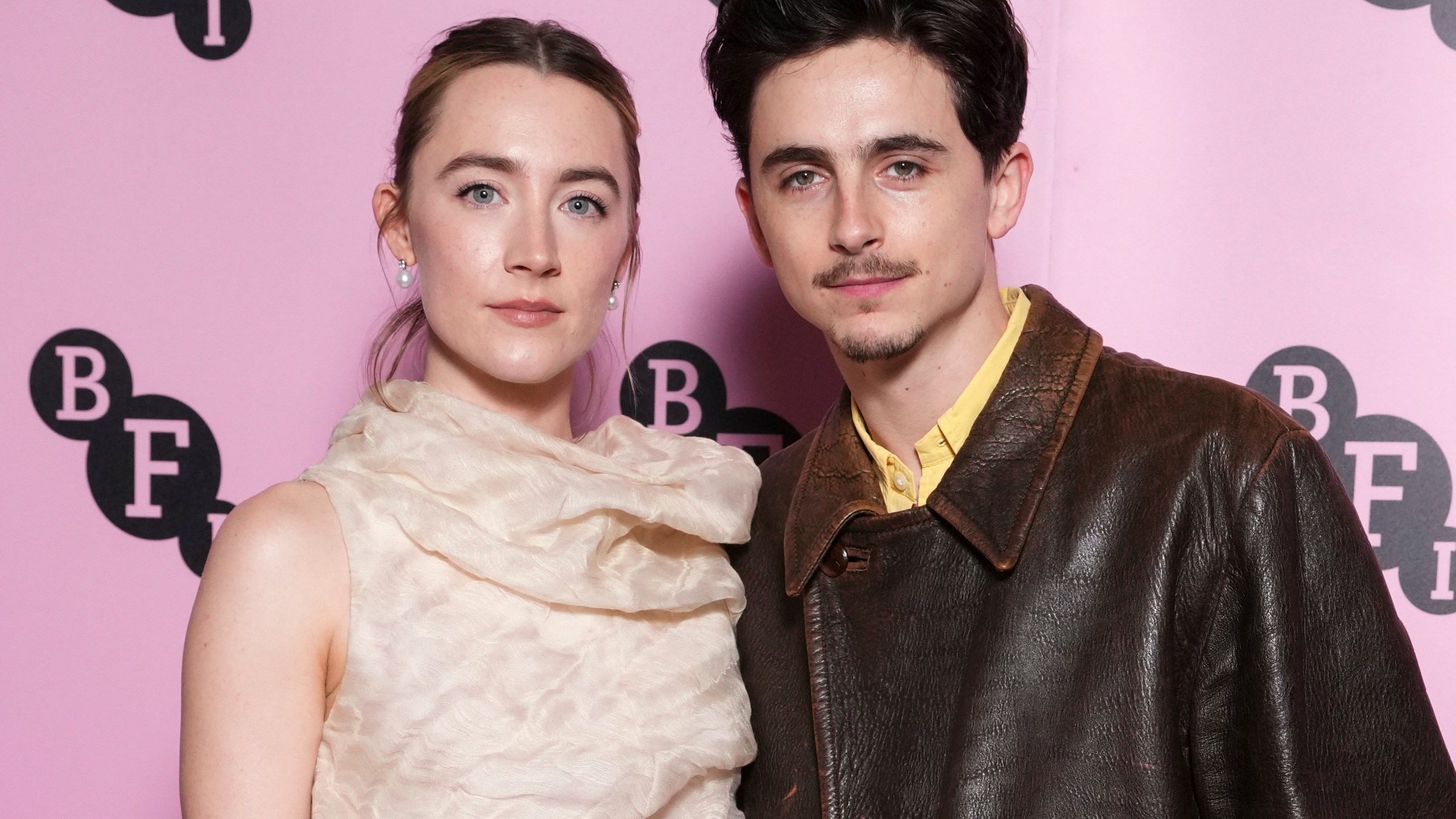 Saoirse Ronan, left, and Timothee Chalamet pose for photographers upon arrival at the photo call for an 'In Conversation' event at the BFI Southbank, on Wednesday, Dec. 18, 2024, in London. (Photo by Scott A Garfitt/Invision/AP)