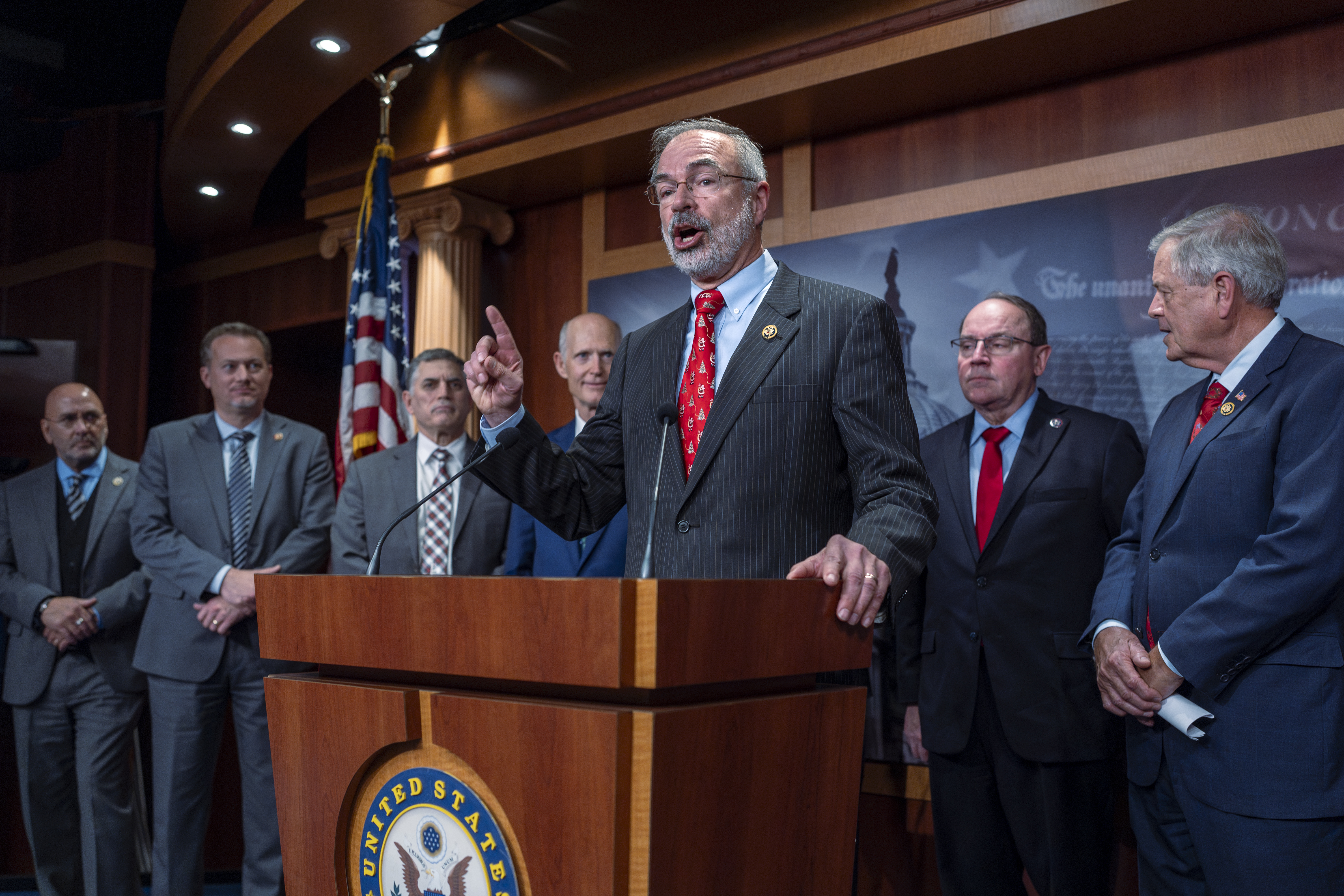 Rep. Andy Harris, R-Md., chairman of the House Freedom Caucus, joins a group of conservative Republicans to complain to reporters about the interim spending bill being crafted to avoid a shutdown of federal agencies, at the Capitol in Washington, Wednesday, Dec. 18, 2024. (AP Photo/J. Scott Applewhite)