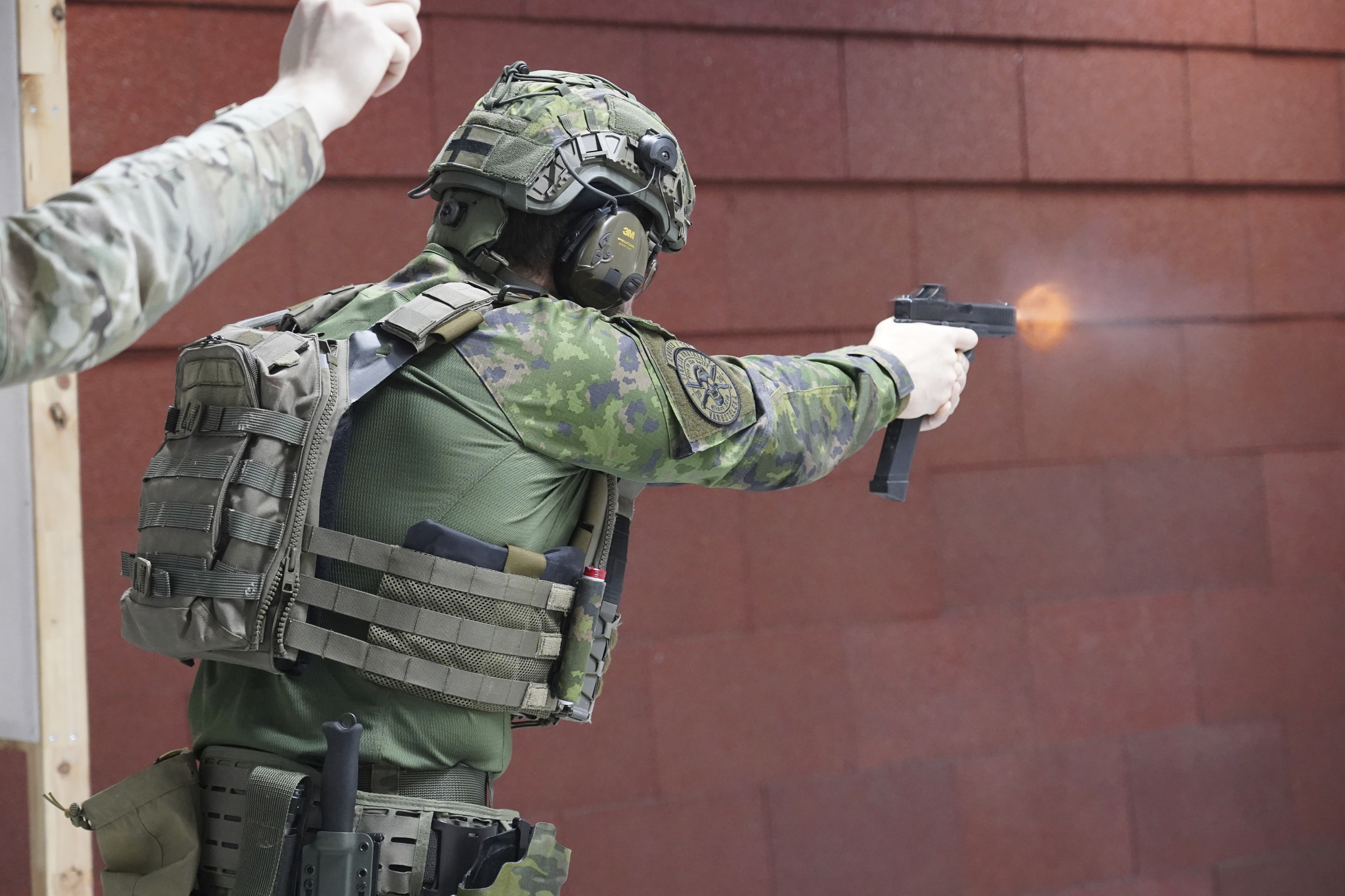 Members of the Vantaa Reservists Association practice at a shooting range in a warehouse in Kerava on the outskirts of Helsinki, Finland Monday, Dec. 2, 2024. (AP Photo/James Brooks)