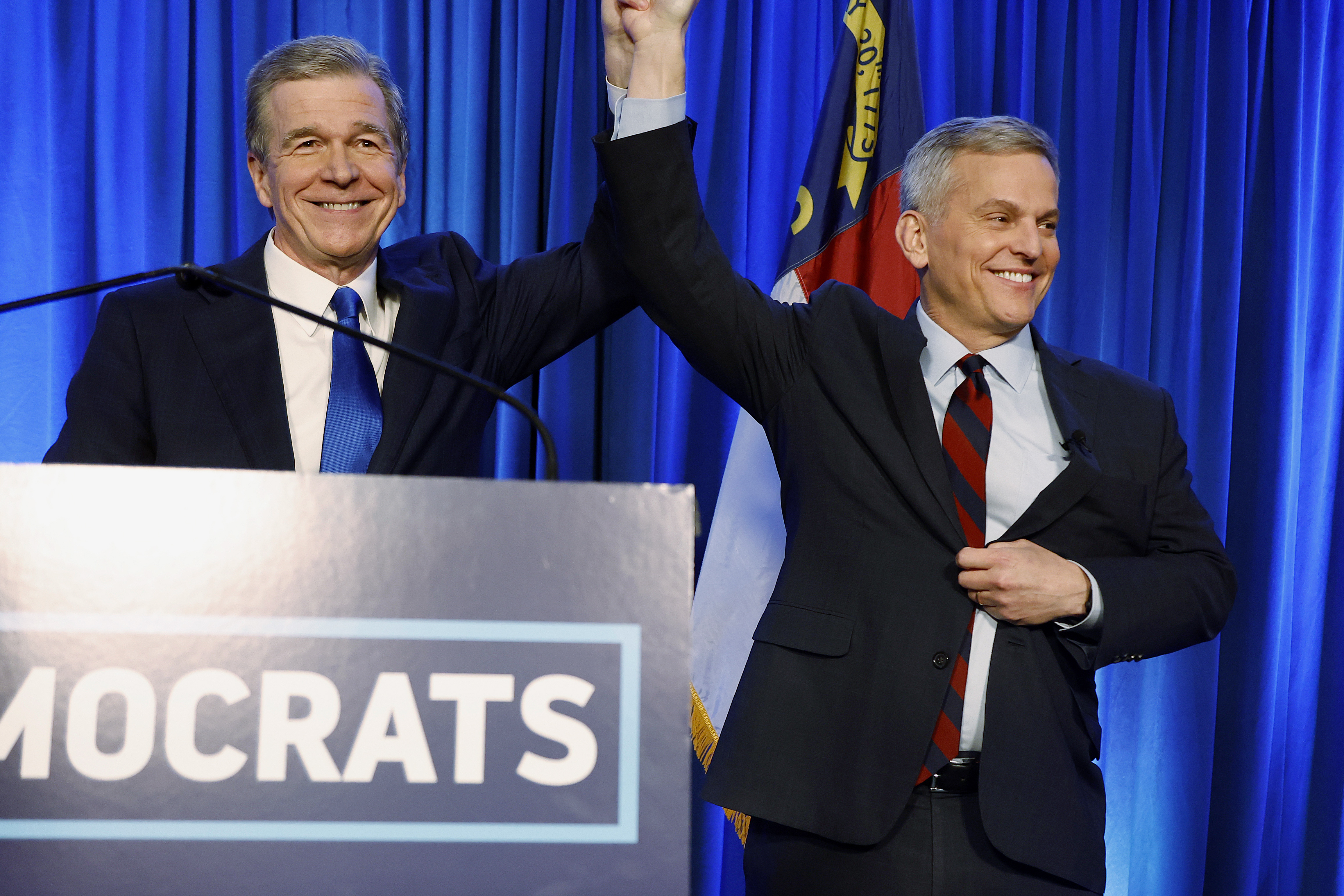 FILE - North Carolina's Democratic gubernatorial candidate Josh Stein, right, is introduced by North Carolina Gov. Roy Cooper at a primary election night party in Raleigh, N.C., March 5, 2024. (AP Photo/Karl B DeBlaker, File)