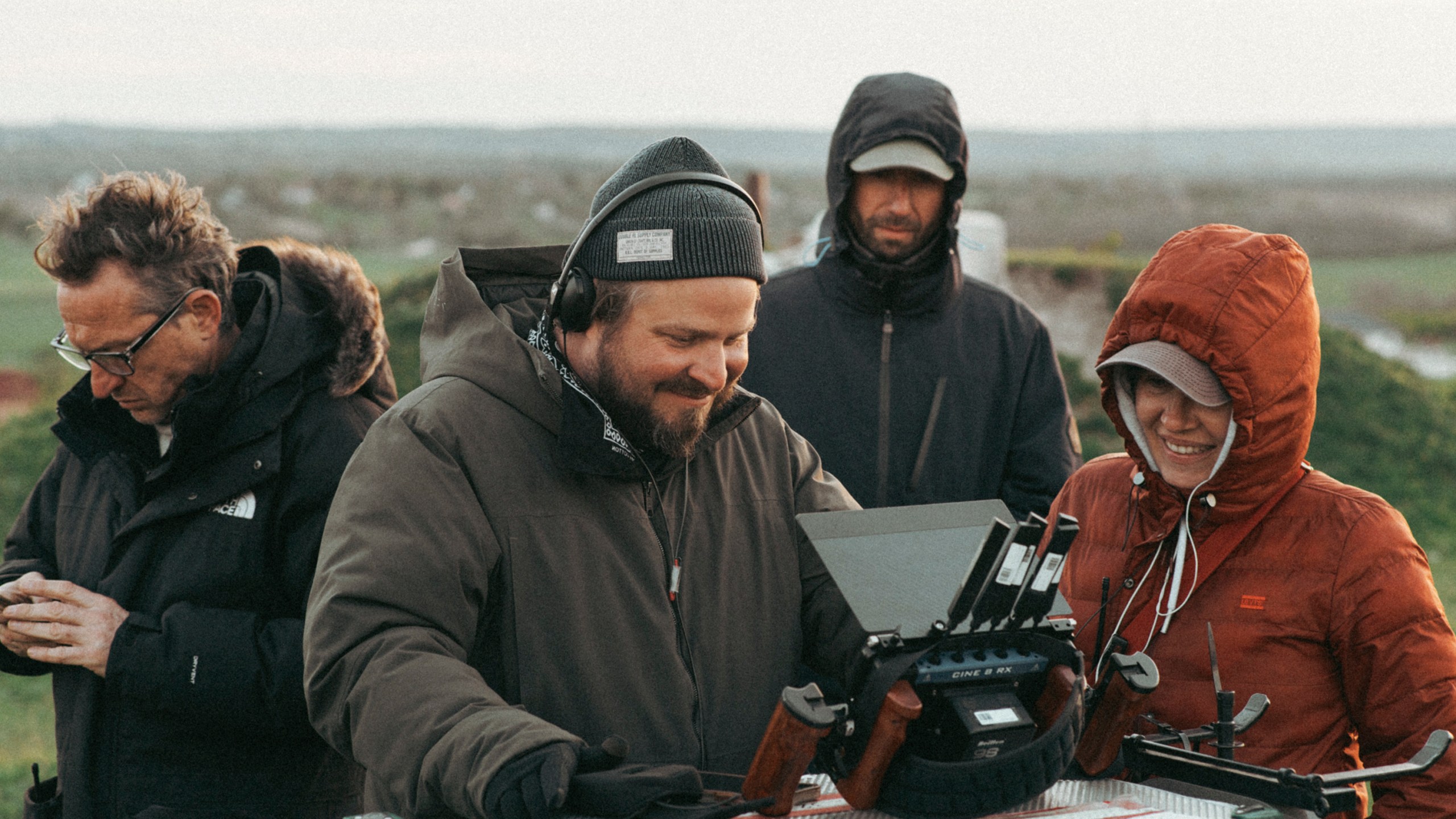 This image released by A24 shows filmmaker Brady Corbet, center, appears on the set of "The Brutalist." (A24 via AP)