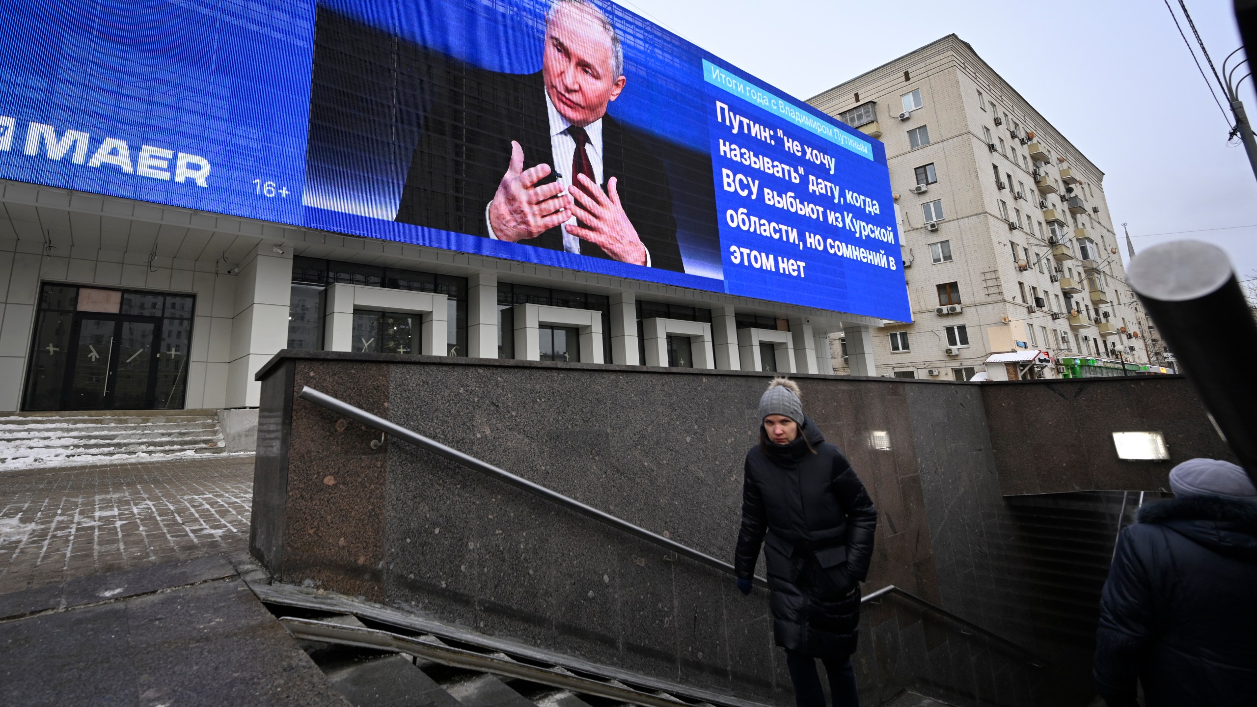 An electronic billboard on a building shows Russian President Vladimir Putin giving his annual news conference and call-in show in Moscow, Russia, Thursday, Dec. 19, 2024. (AP Photo/Dmitry Serebryakov)