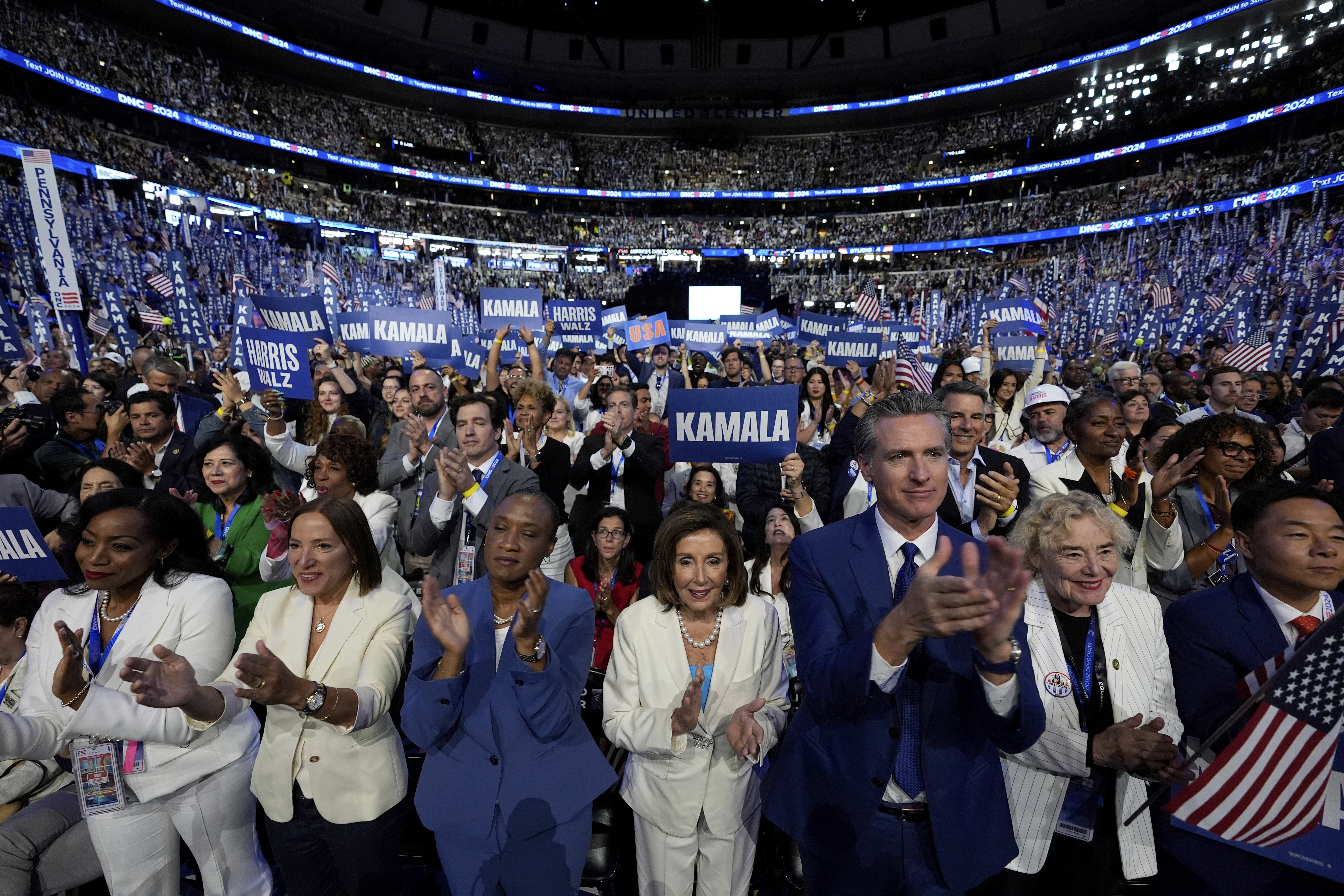 FILE - Rep. Nancy Pelosi, D-Calif., center, and California Gov. Gavin Newsom, center right, applaud as Democratic presidential nominee Vice President Kamala Harris speaks during the Democratic National Convention, in Chicago, Aug. 22, 2024. (AP Photo/Paul Sancya, File)