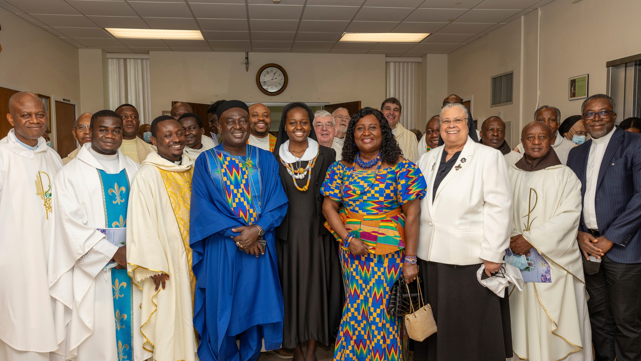 In this photo provided by Edem M. Adzokpa, Sister Seyram Mary Adzokpa, center, is surrounded by her fellow sisters, friends and family after making her first profession at the Sisters of the Holy Family in New Orleans on Thursday, Aug. 15, 2024. (Edem M. Adzokpa via AP)