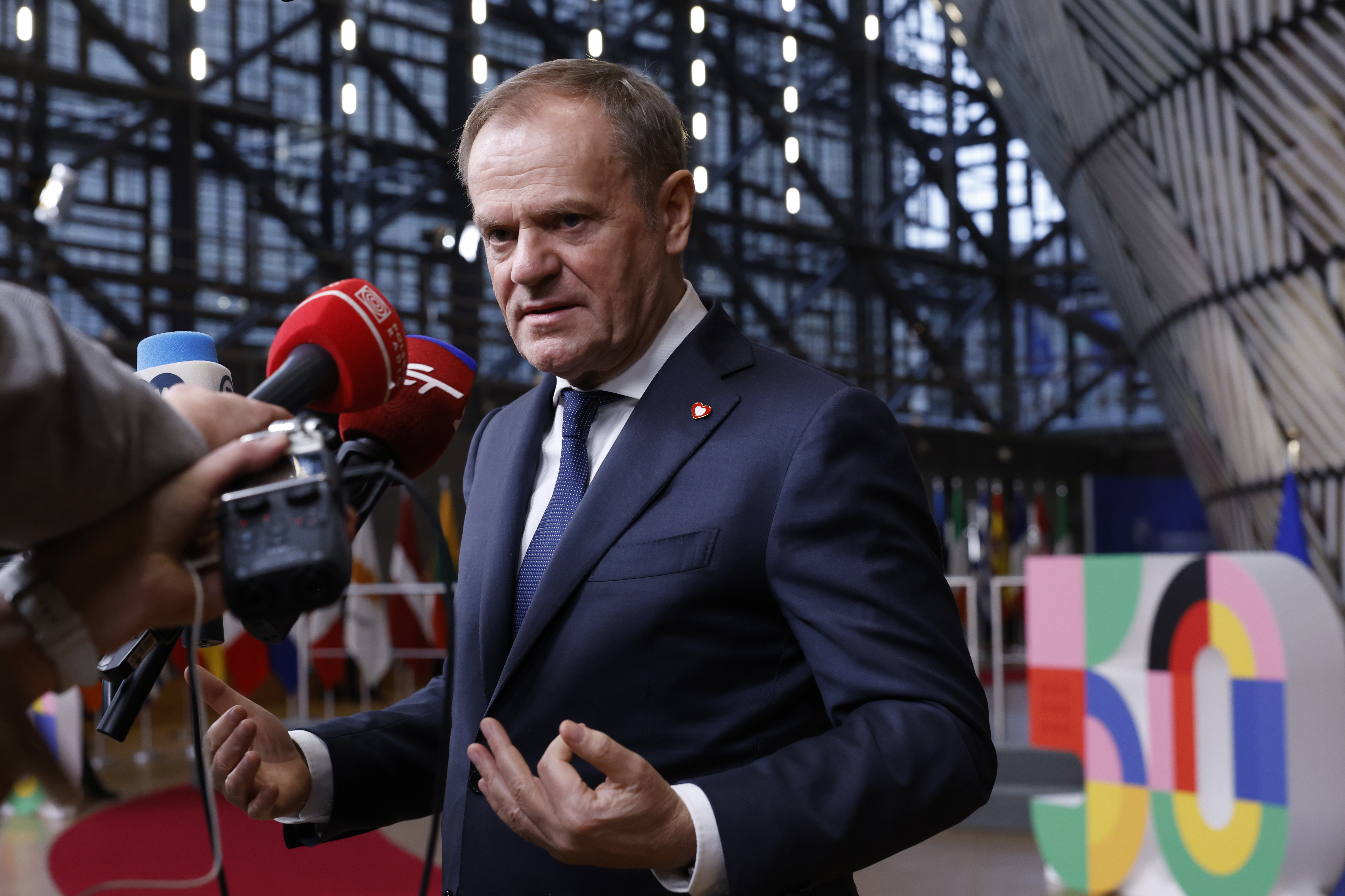 Poland's Prime Minister Donald Tusk speaks with the media prior to a group photo at an EU summit in Brussels, Thursday, Dec. 19, 2024. (AP Photo/Omar Havana)