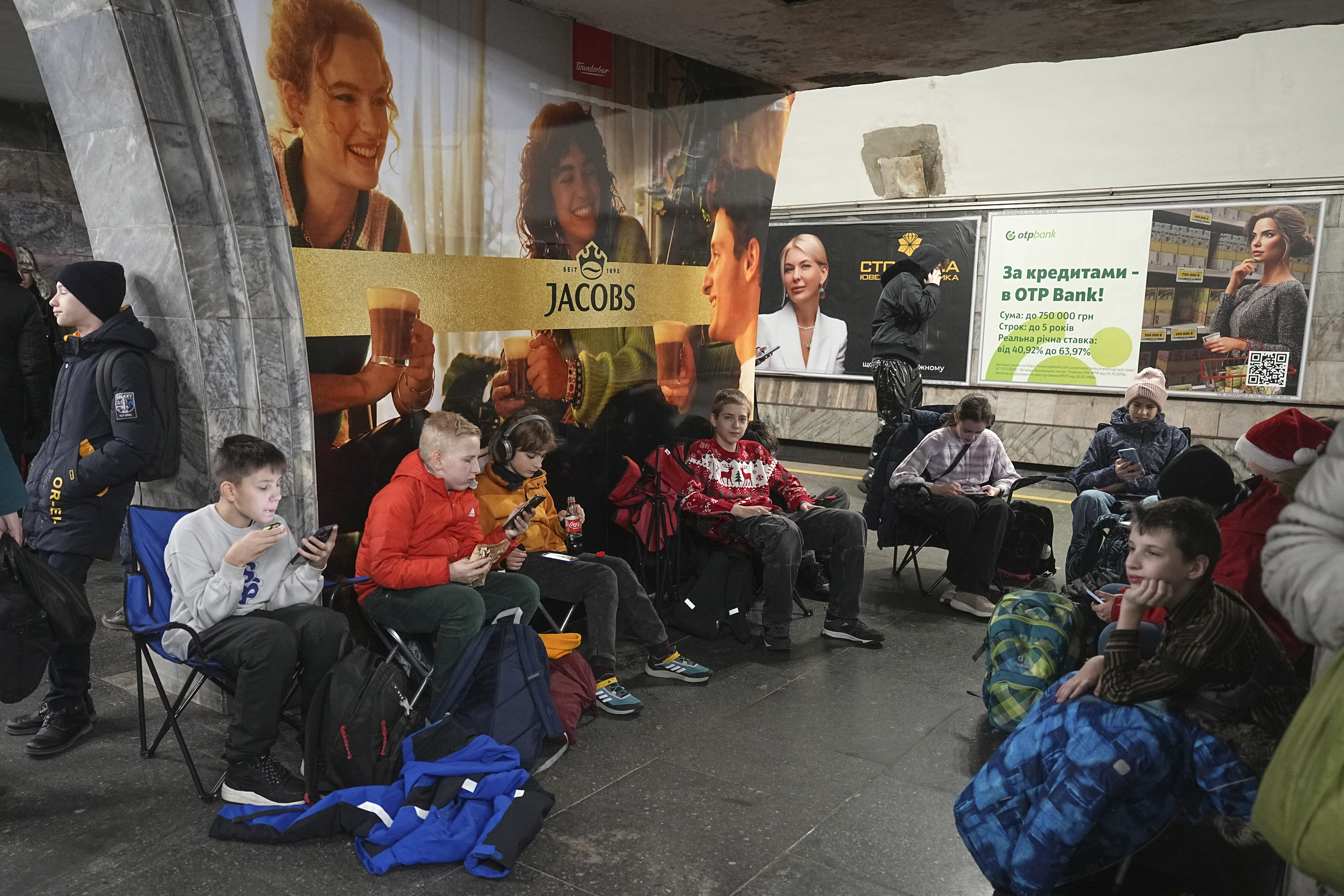 People take shelter in a metro station during an air raid alarm in Kyiv, Ukraine, Friday, Dec. 20, 2024. (AP Photo/Efrem Lukatsky)