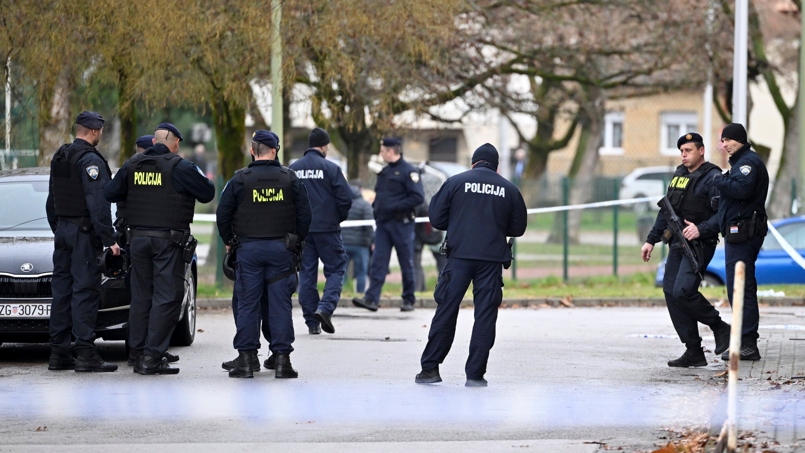 Police secure access to the elementary school where a 7-year-old girl died and a teacher and five other students were wounded in a knife attack in Zagreb, Croatia, Friday, Dec. 20, 2024. (AP Photo/Damir Krajac)