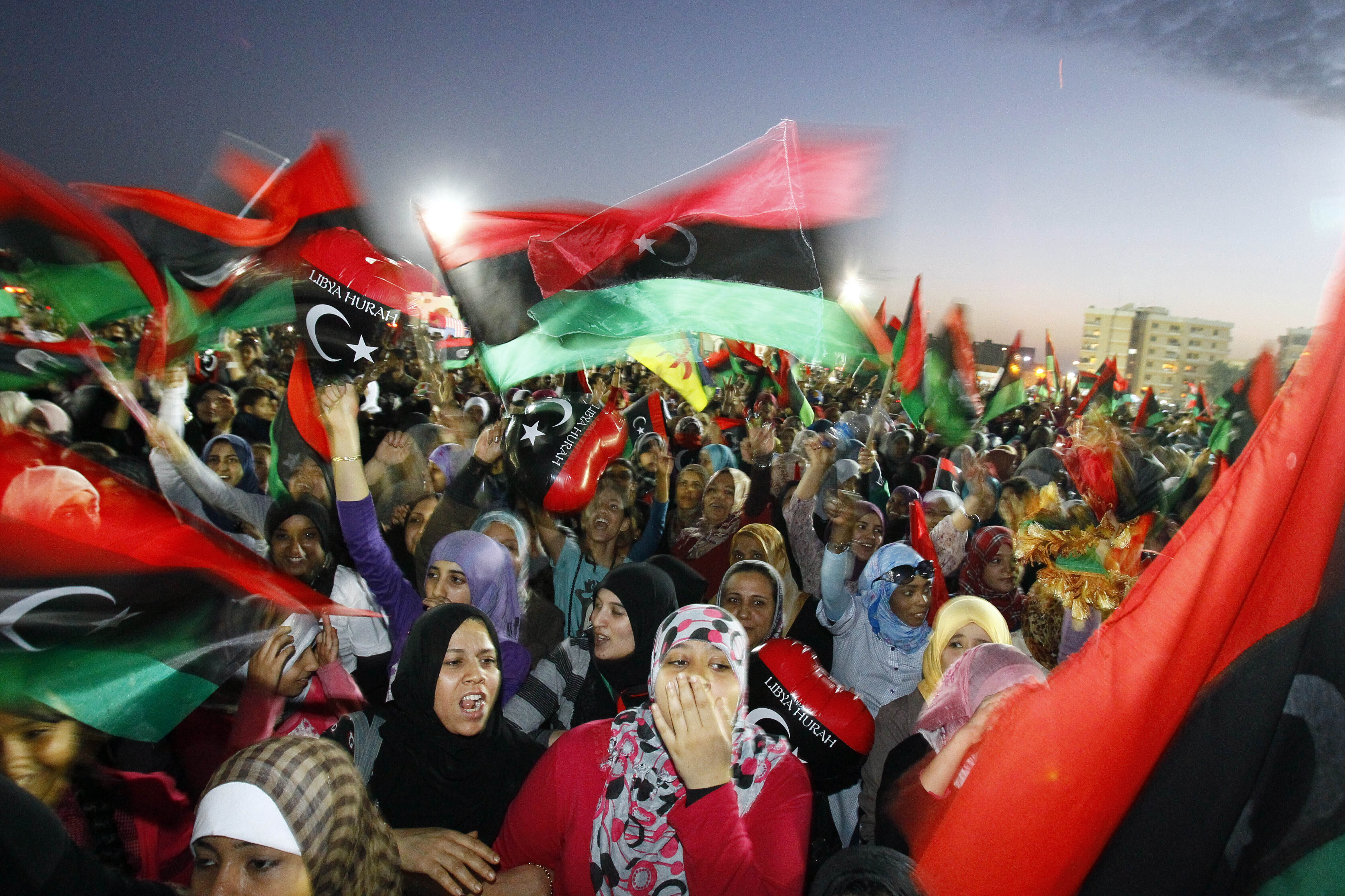 FILE - Libyans celebrate the official liberation of Libya after months of bloodshed that culminated in the death of longtime leader Moammar Gadhafi, at Saha Kish Square in Benghazi, Libya, on Oct. 23, 2011. (AP Photo/Francois Mori, File)