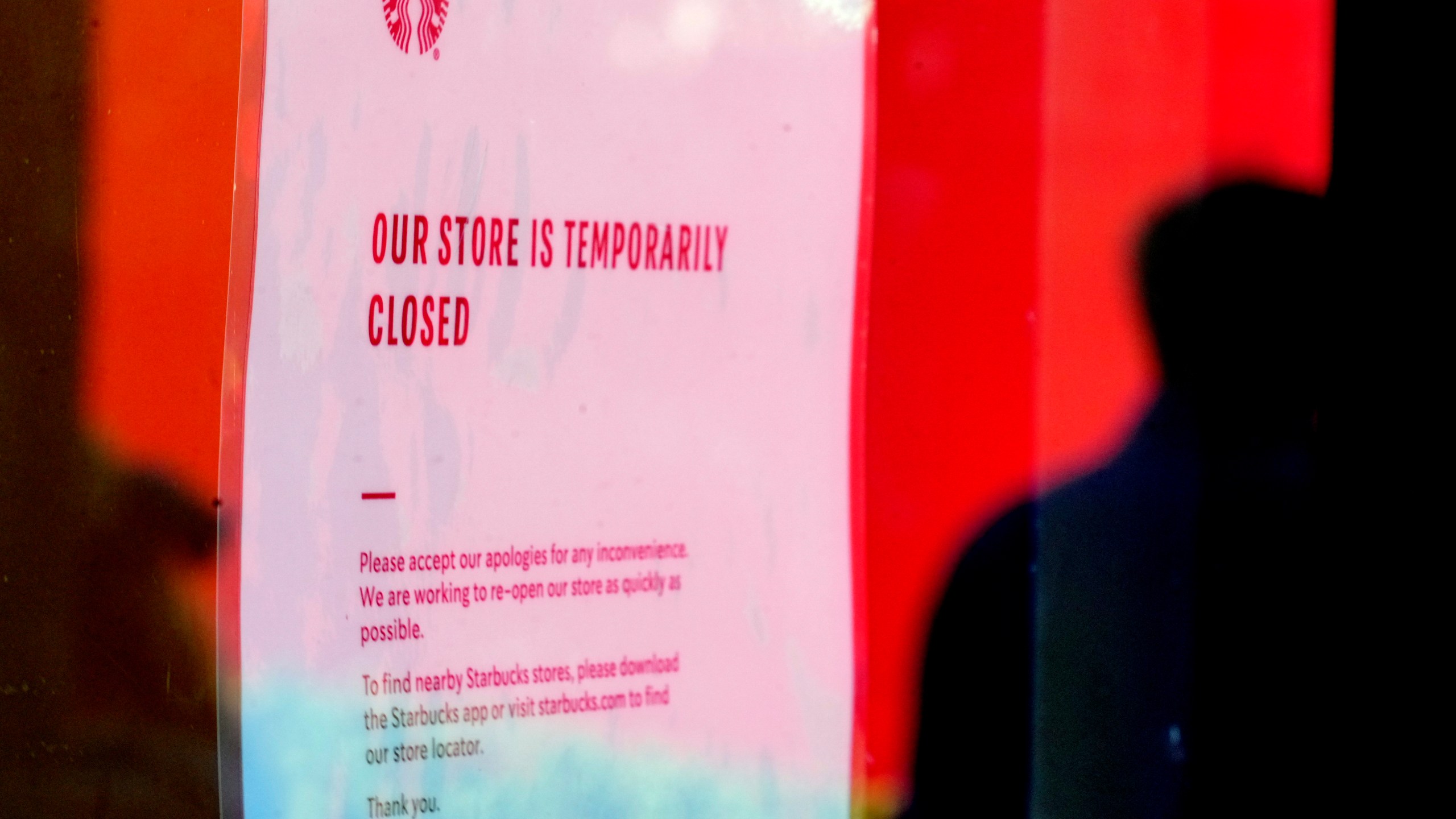 A closed store sign is seen in the window of a Starbucks as workers picket outside the location on company Friday, Dec. 20, 2024, in Burbank, Calif. (AP Photo/Damian Dovarganes)