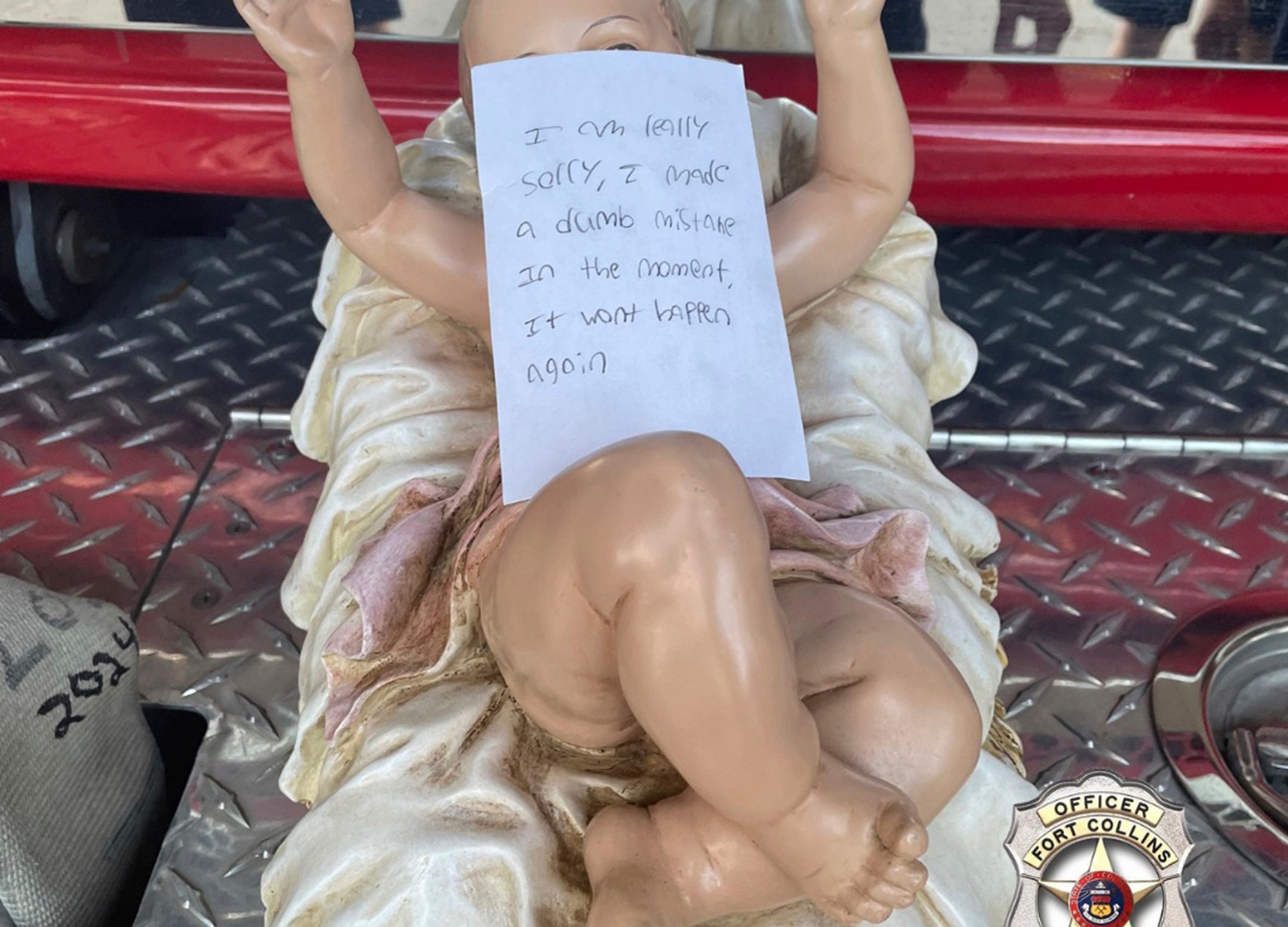 This photo provided by the Fort Collins, Colo., Police shows a note on a baby Jesus figurine snatched from a nativity scene, after it was dropped off anonymously at a fire station Thursday, Dec. 19, 2024, police said. (Fort Collins Police via AP)