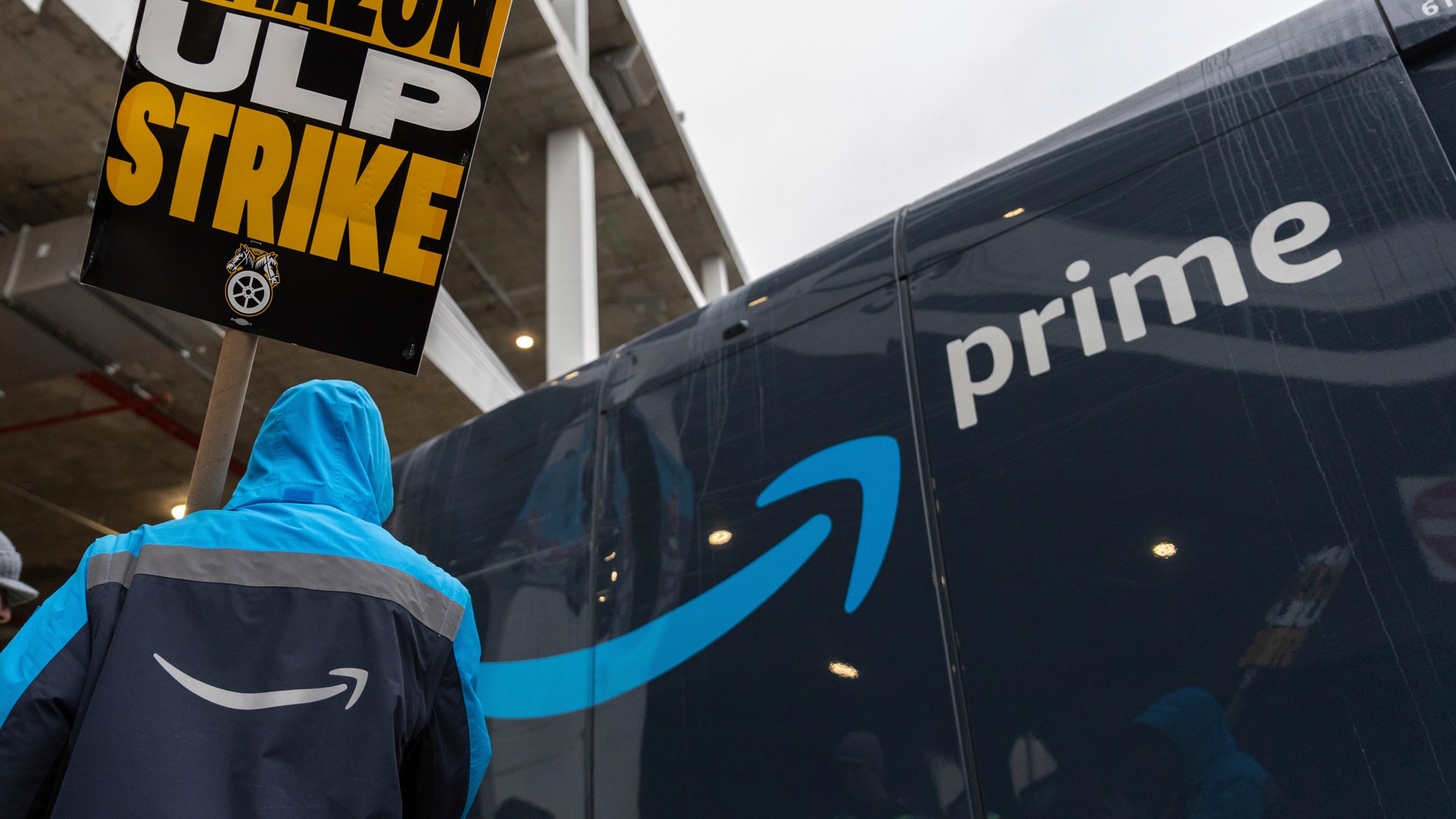 Amazon workers and members of the International Brotherhood of Teamsters picket in front of the Amazon fulfillment center in the Queens borough of New York, Friday, Dec. 20, 2024. (AP Photo/Stefan Jeremiah)