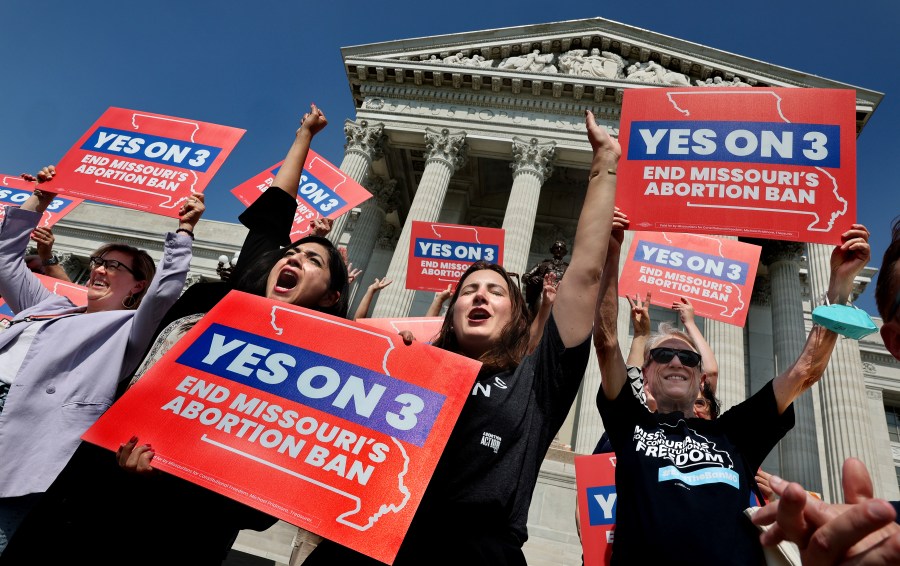 FILE - Amendment 3 supporters Luz Maria Henriquez, second from left, executive director of the ACLU Missouri, celebrates with Mallory Schwarz, center, of Abortion Action Missouri, after the Missouri Supreme Court in Jefferson City, Mo., ruled that the amendment to protect abortion rights would stay on the November ballot. Abortion-rights advocates will ask a judge Wednesday, Dec. 4, 2024 to overturn Missouri’s near-total ban on the procedure, less than a month after voters backed an abortion-rights constitutional amendment. (Robert Cohen/St. Louis Post-Dispatch via AP, File)